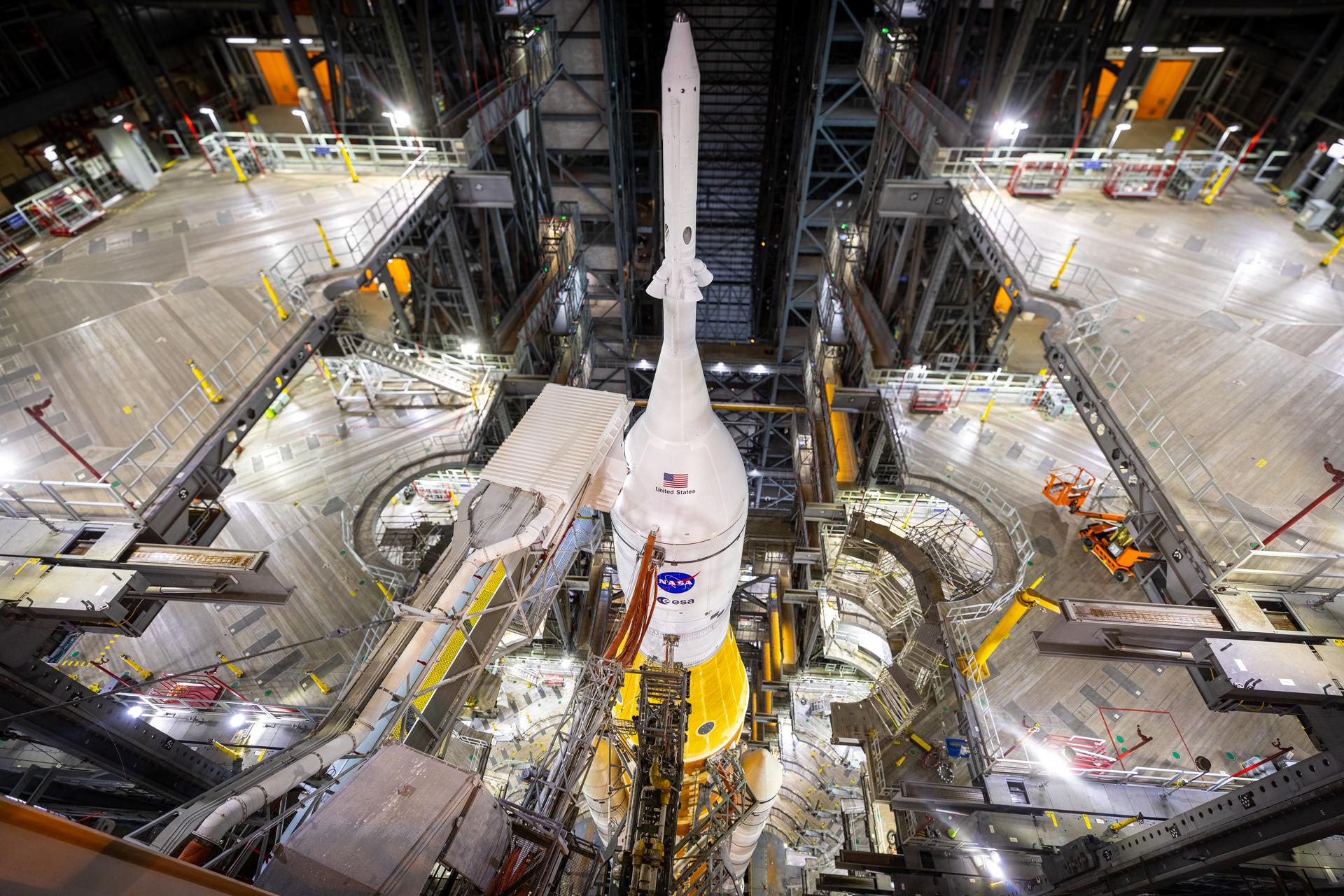 In this view looking down in High Bay 3 inside the Vehicle Assembly Building on Saturday, Jan. 17, 2026, the work platforms are retracted around NASA’s Artemis II SLS (Space Launch System) rocket and Orion spacecraft in preparation for rollout to Launch Complex 39B at NASA’s Kennedy Space Center in Florida. NASA’s Artemis II flight test will take Commander Reid Wiseman, Pilot Victor Glover, and Mission Specialist Christina Koch from NASA, and Mission Specialist Jeremy Hansen from the CSA (Canadian Space Agency), around the Moon and back to Earth no later than no later than April 2026.
