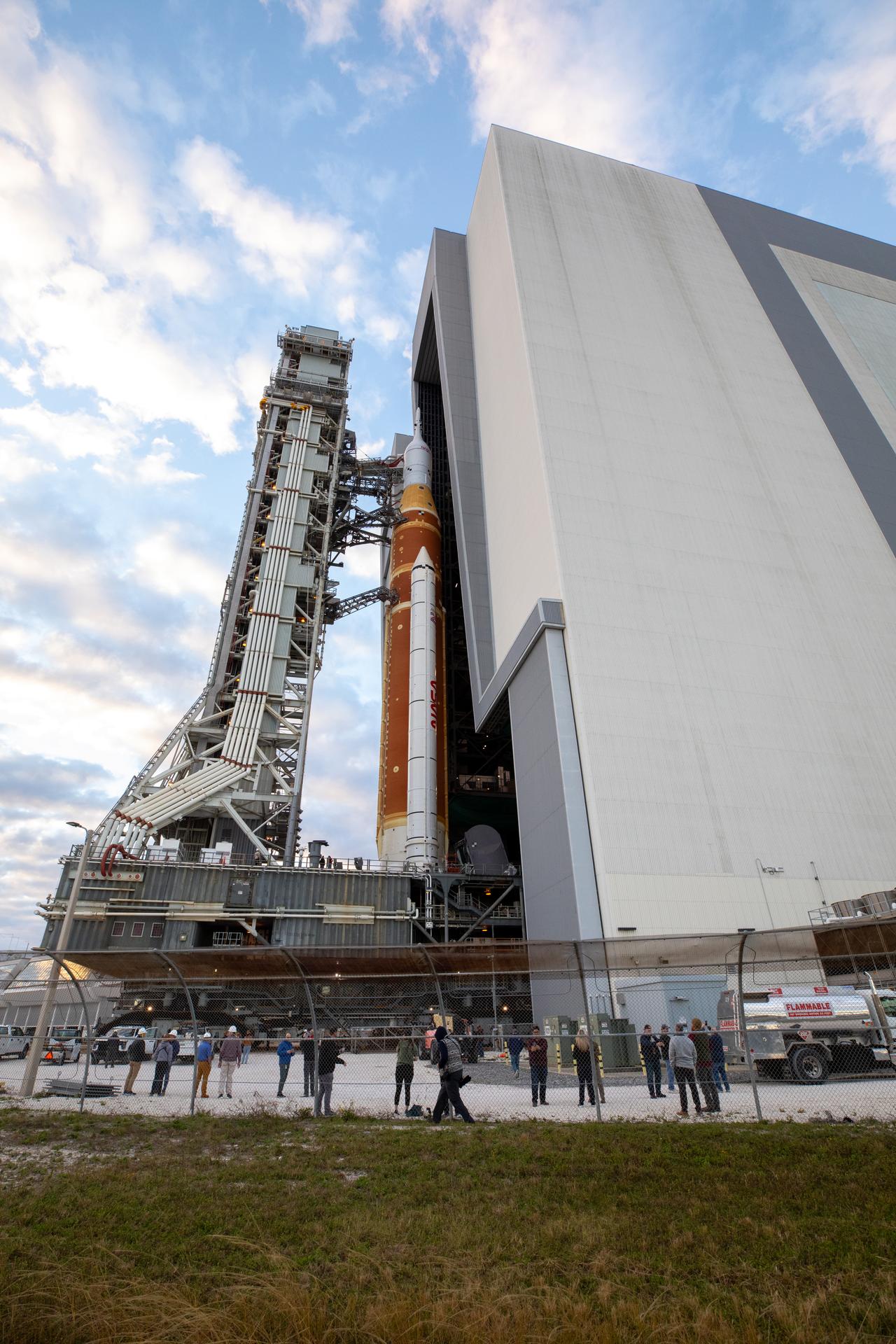 NASA’s crawler-transporter 2 carrying the agency’s Artemis II SLS (Space Launch System) rocket and Orion spacecraft, secured to the mobile launcher, begins rolling out from High Bay 3 inside the Vehicle Assembly Building to Launch Complex 39B at NASA’s Kennedy Space Center in Florida on Saturday, Jan. 17, 2026. The Artemis II test flight will take Commander Reid Wiseman, Pilot Victor Glover, and Mission Specialist Christina Koch from NASA and Mission Specialist Jeremy Hansen from the CSA (Canadian Space Agency), around the Moon and back to Earth no later than April 2026.