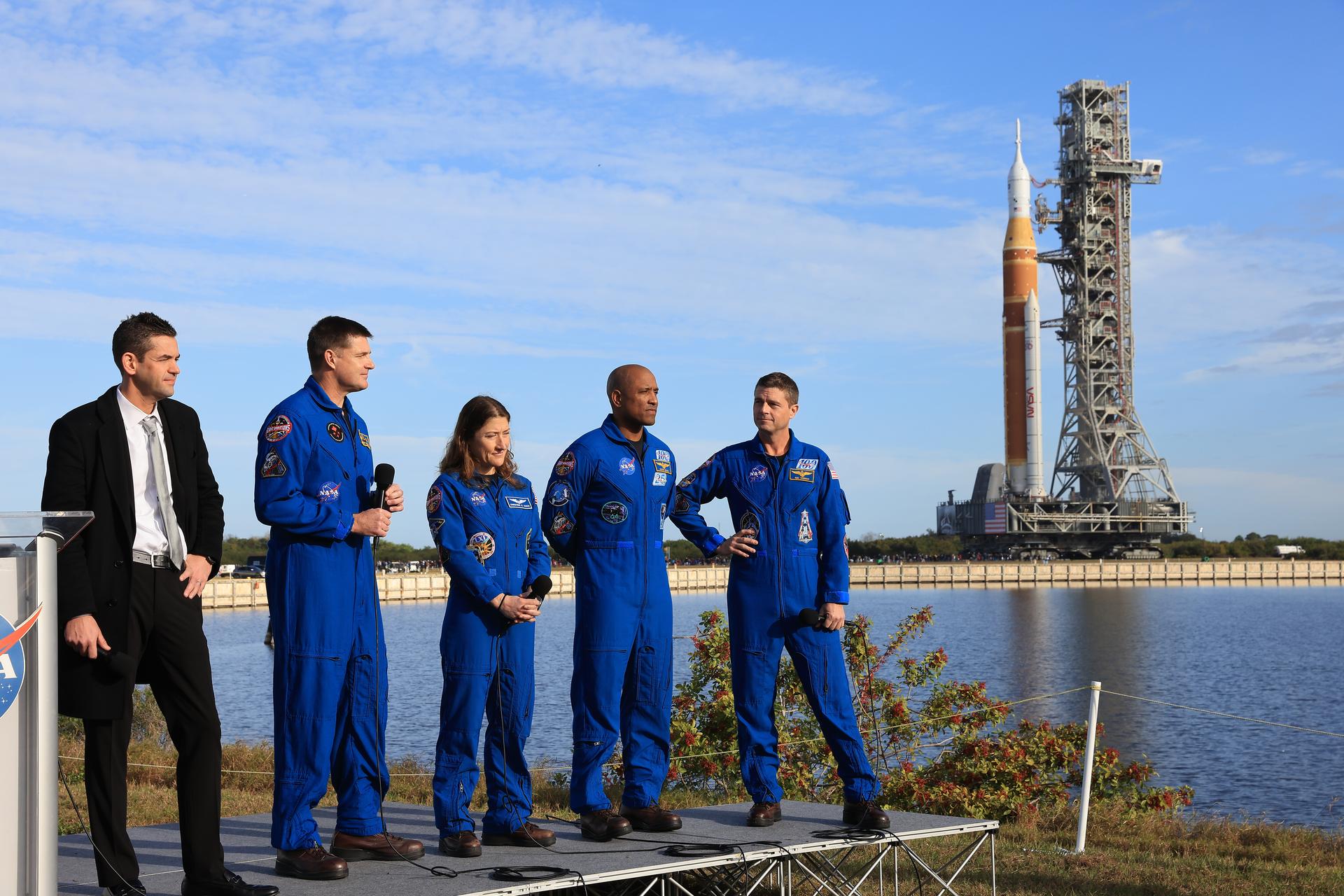 From left to right, NASA Administrator Jared Isaacman, Artemis II NASA astronauts Reid Wiseman, commander; Victor Glover, pilot, and Christina Koch, mission specialist, and CSA (Canadian Space Agency) Jeremy Hansen, mission specialist, speak to members of the media during NASA’s Artemis II SLS (Space Launch System) rocket and Orion spacecraft rollout to Launch Complex 39B at NASA’s Kennedy Space Center in Florida on Saturday, Jan. 17, 2026. In the coming weeks, engineers will prepare for the wet dress rehearsal, a two-day test that simulates launch day. The Artemis II test flight will take Commander Reid Wiseman, Pilot Victor Glover, and Mission Specialist Christina Koch from NASA, and Mission Specialist Jeremy Hansen from the CSA (Canadian Space Agency), around the Moon and back to Earth no later than April 2026. 