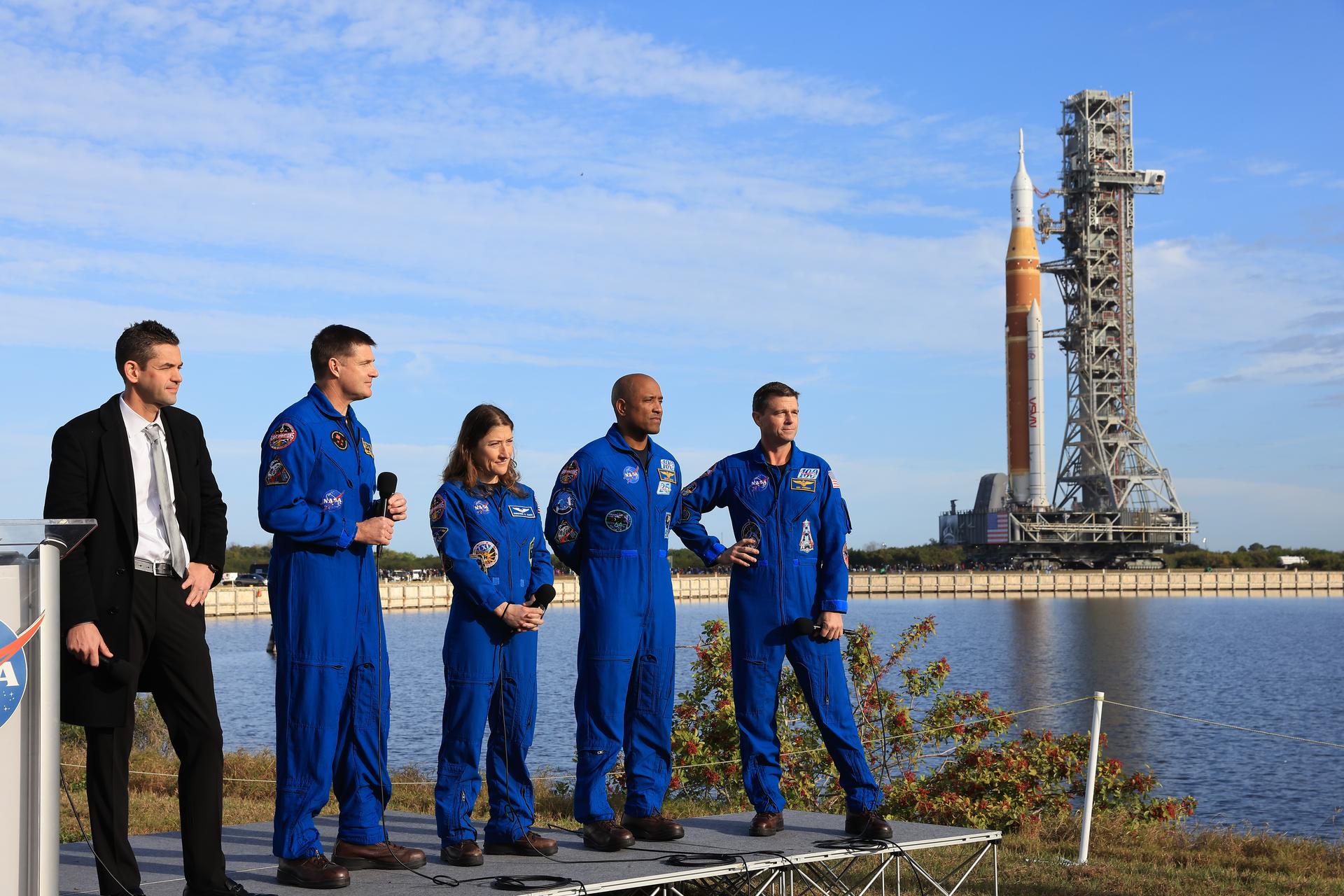 From left to right, NASA Administrator Jared Isaacman, Artemis II NASA astronauts Reid Wiseman, commander; Victor Glover, pilot, and Christina Koch, mission specialist, and CSA (Canadian Space Agency) Jeremy Hansen, mission specialist, speak to members of the media during NASA’s Artemis II SLS (Space Launch System) rocket and Orion spacecraft rollout to Launch Complex 39B at NASA’s Kennedy Space Center in Florida on Saturday, Jan. 17, 2026. In the coming weeks, engineers will prepare for the wet dress rehearsal, a two-day test that simulates launch day. The Artemis II test flight will take Commander Reid Wiseman, Pilot Victor Glover, and Mission Specialist Christina Koch from NASA, and Mission Specialist Jeremy Hansen from the CSA (Canadian Space Agency), around the Moon and back to Earth no later than April 2026. 