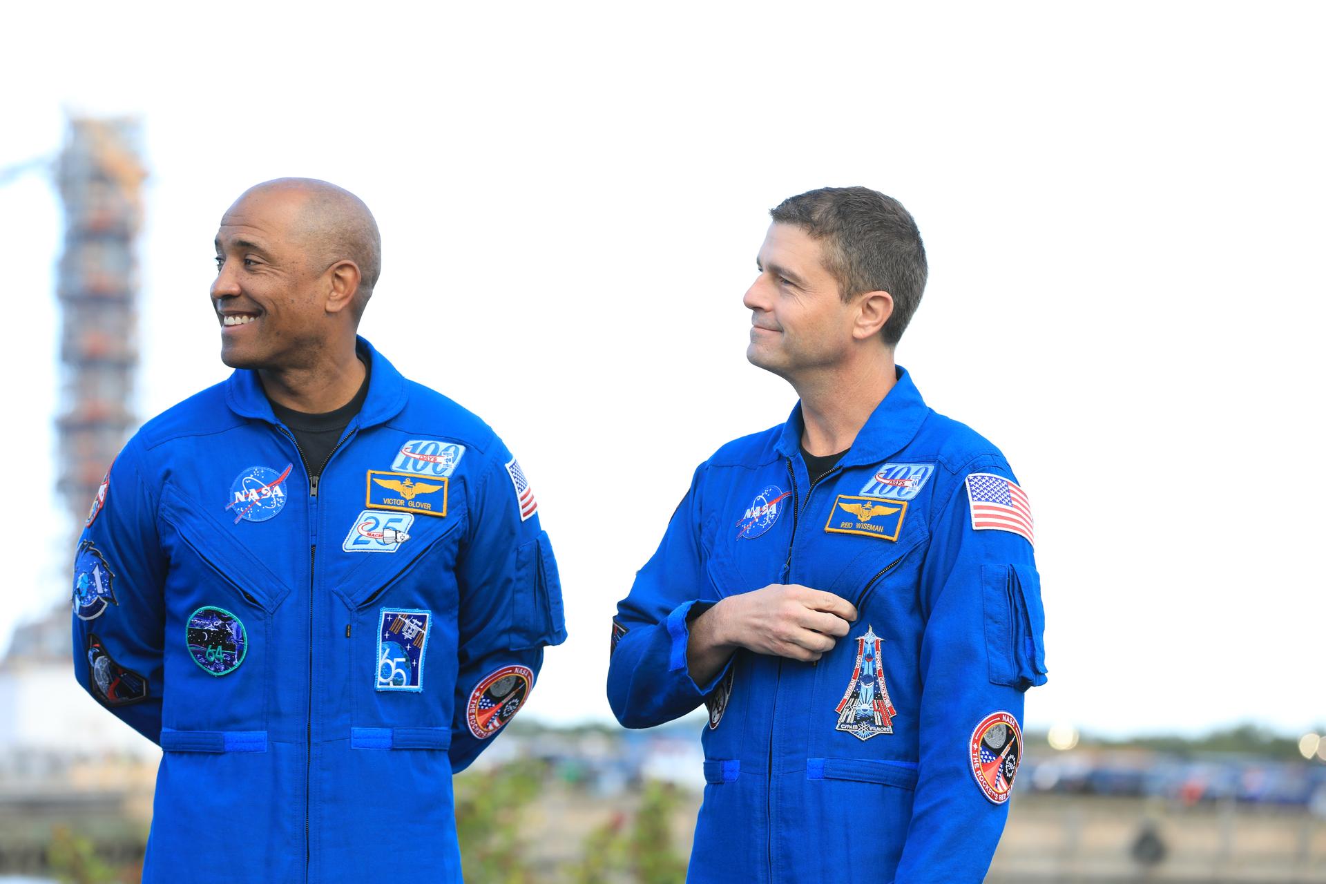 From left, Artemis II Pilot Victor Glover, from NASA, and Artemis II Commander Reid Wiseman, from NASA, speak to members of the media as NASA’s Artemis II SLS (Space Launch System) rocket and Orion spacecraft rolls out to Launch Complex 39B at NASA’s Kennedy Space Center in Florida on Saturday, Jan. 17, 2026. In the coming weeks, engineers will prepare for the wet dress rehearsal, a two-day test that simulates launch day. The Artemis II test flight will take Hansen, Glover, Koch, and Commander Reid Wiseman (not pictured), from NASA, around the Moon and back to Earth no later than April 2026. 
