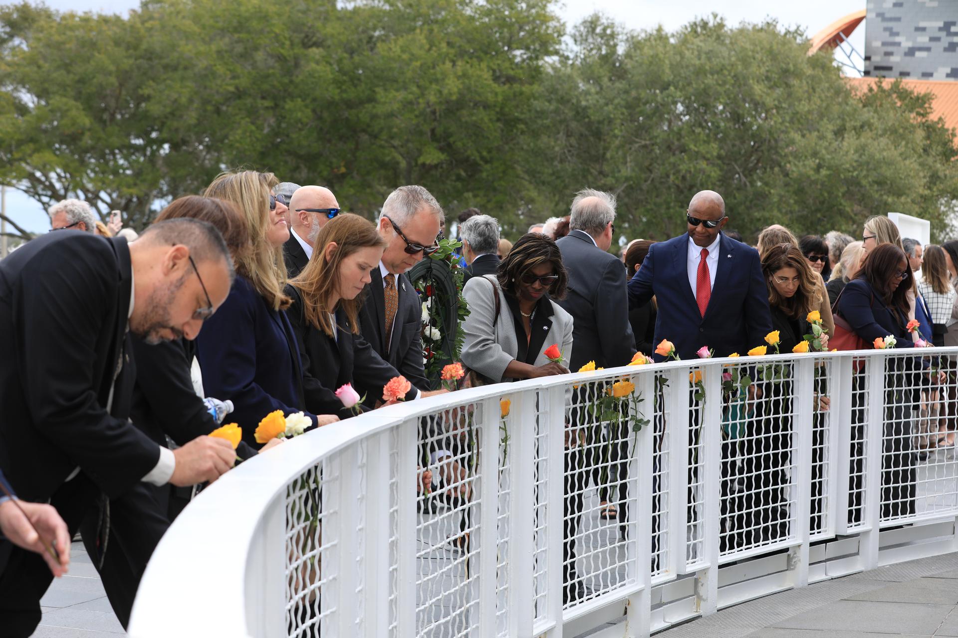 NASA’s Kennedy Space Center Deputy Director Kelvin Manning (far right) and fellow NASA employees place flowers before the Space Mirror Memorial at the Kennedy Space Center Visitor Complex in Florida during NASA’s Day of Remembrance on Thursday, Jan. 22, 2026. The mirror was dedicated in 1991 to honor all astronauts who lost their lives on missions or during training. During the annual event, NASA centers across the country honor those astronauts who have fallen in the pursuit of space exploration. This year marks the 40th anniversary of the Challenger tragedy.