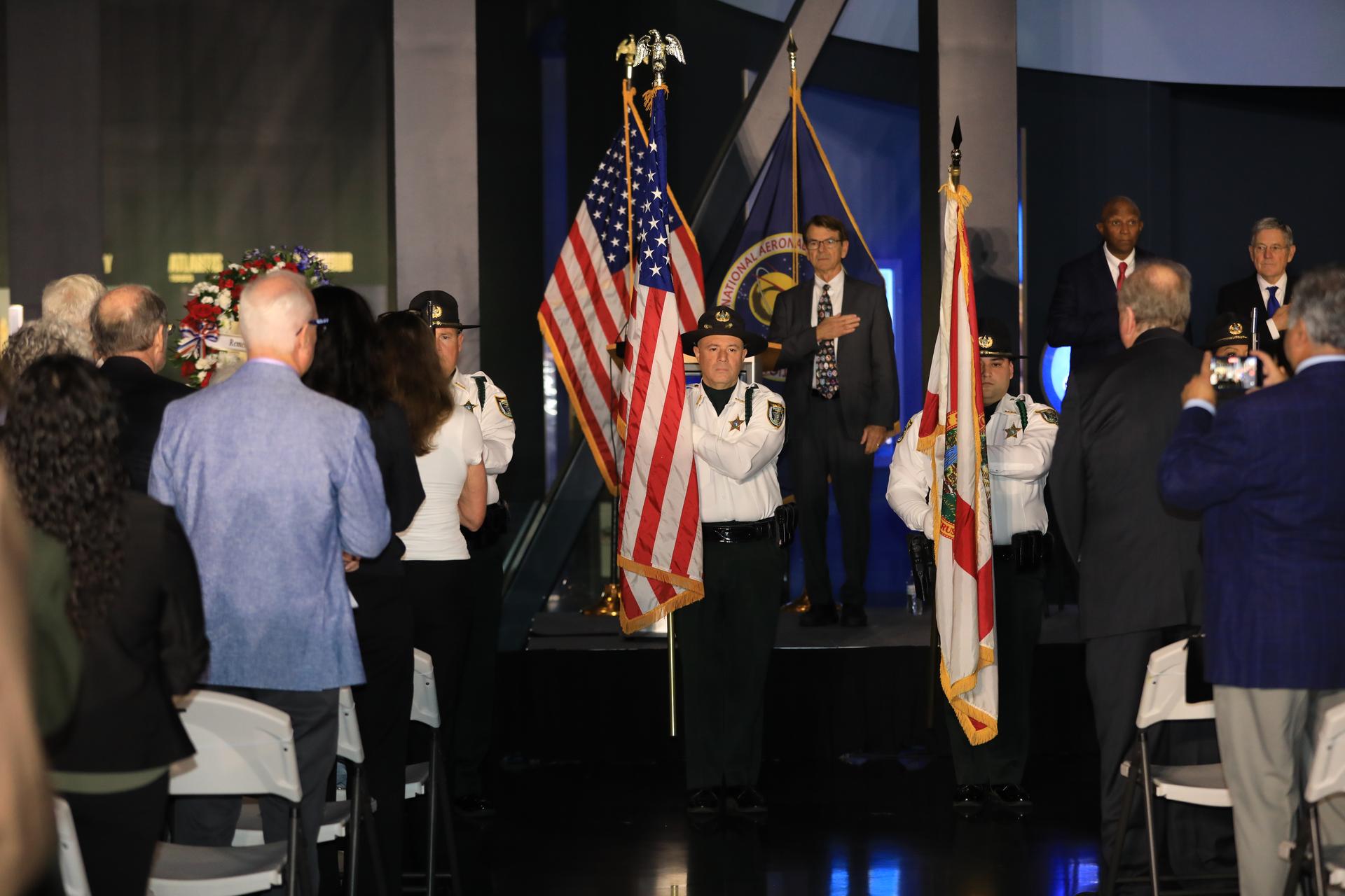 Astronauts Memorial Foundation president and CEO Thad Altman (center) stands as the Brevard County Sheriff’s Office Honor Guard presents colors during NASA’s Day of Remembrance ceremony on Thursday, Jan. 22, 2026, at the Kennedy Space Center Visitor Complex in Florida. The crews of Apollo 1 and space shuttles Challenger and Columbia, as well as other fallen astronauts who lost their lives in the name of space exploration and discovery, were honored by Kennedy employees and guests at the annual memorial event. This year marks the 40th anniversary of the Challenger tragedy.