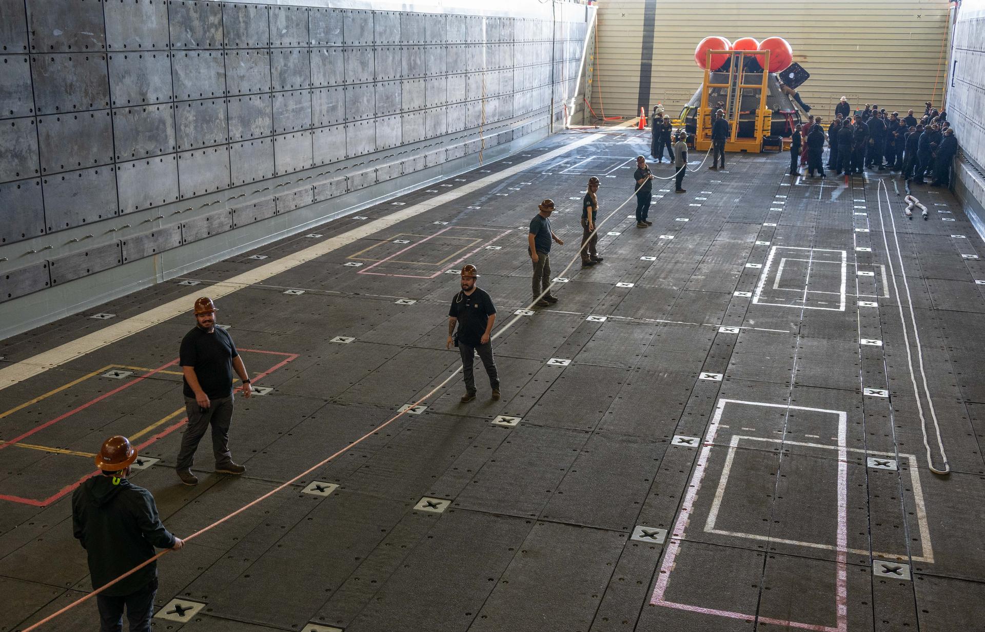 Off the coast of California, NASA’s Artemis Landing and Recovery team and the Department of War that will work together to retrieve the Artemis II crew and Orion spacecraft following their return to Earth and splashdown in the Pacific Ocean are performing a final simulation of their activities, called a just-in-time training, at sea on Monday, Jan. 26, 2026. During the training, teams use the Crew Module Test Article, a full-scale mockup of the Orion spacecraft, to simulate as close as possible the conditions they can expect to encounter during splashdown of the Artemis II mission. NASA’s first crewed test flight in the Artemis campaign, the approximately 10-day Artemis II mission will send NASA astronauts Reid Wiseman, Victor Glover, and Christina Koch, and CSA (Canadian Space Agency) astronaut Jeremy Hansen around the Moon and farther than any humans have ever been from Earth.
