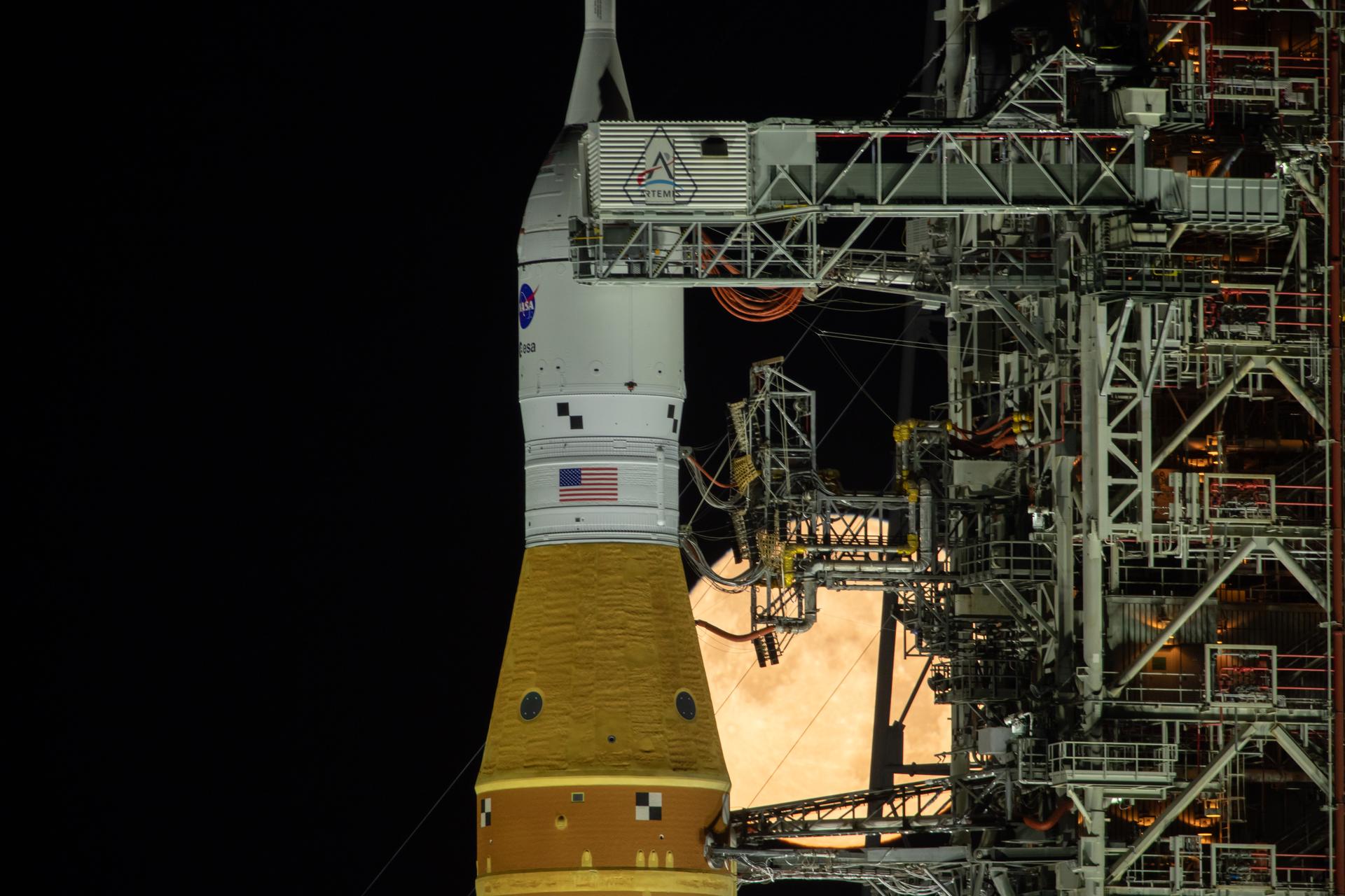 The Moon rises behind NASA’s Artemis II SLS (Space Launch System) rocket and Orion spacecraft atop a mobile launcher at Launch Complex 39B at NASA’s Kennedy Space Center in Florida on Sunday, Feb. 1,. 2026. The Artemis II test flight will take Commander Reid Wiseman, Pilot Victor Glover, and Mission Specialist Christina Koch from NASA, and Mission Specialist Jeremy Hansen from the CSA (Canadian Space Agency), around the Moon and back to Earth.