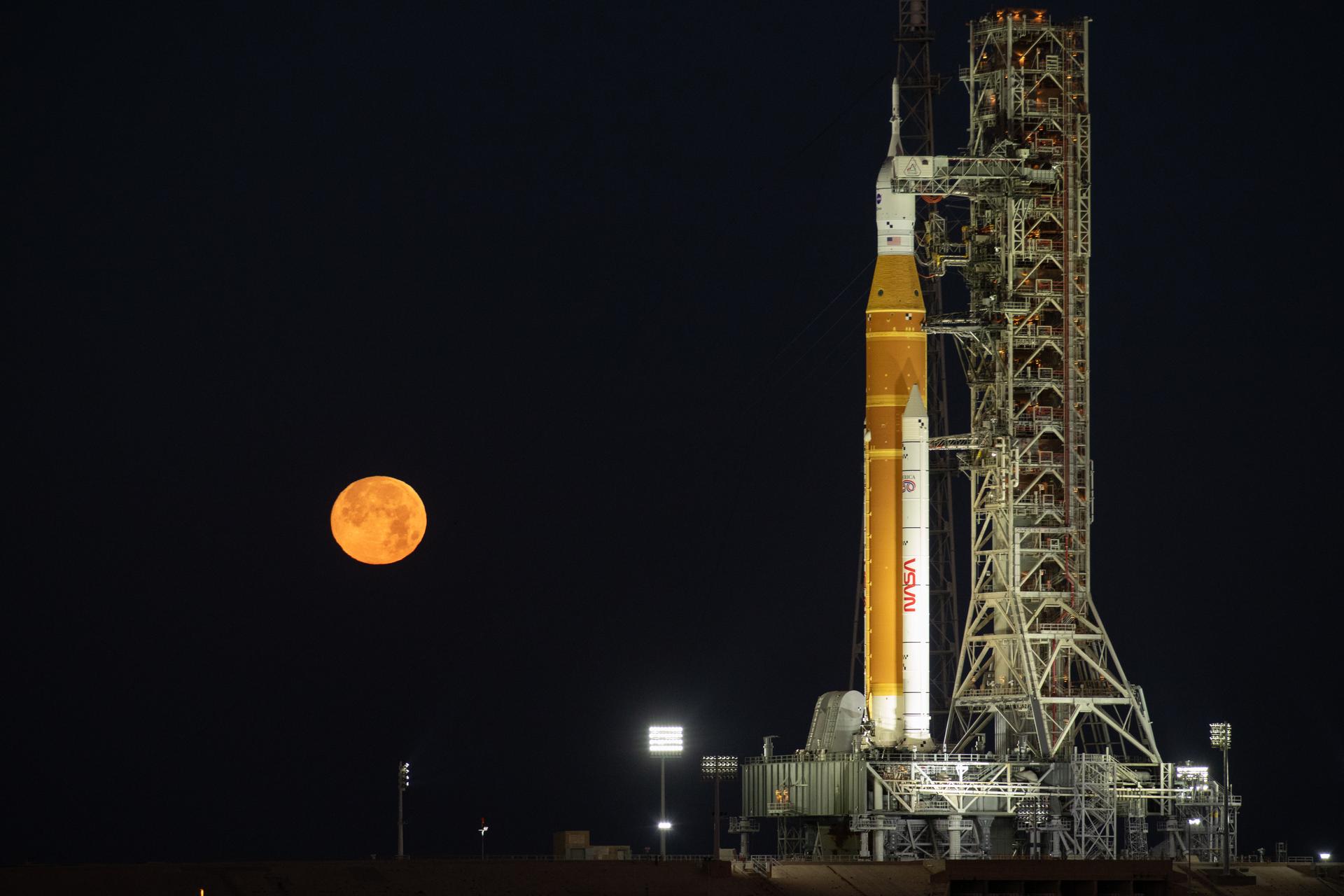The Moon rises behind NASA’s Artemis II SLS (Space Launch System) rocket and Orion spacecraft atop a mobile launcher at Launch Complex 39B at NASA’s Kennedy Space Center in Florida on Sunday, Feb. 1,. 2026. The Artemis II test flight will take Commander Reid Wiseman, Pilot Victor Glover, and Mission Specialist Christina Koch from NASA, and Mission Specialist Jeremy Hansen from the CSA (Canadian Space Agency), around the Moon and back to Earth.