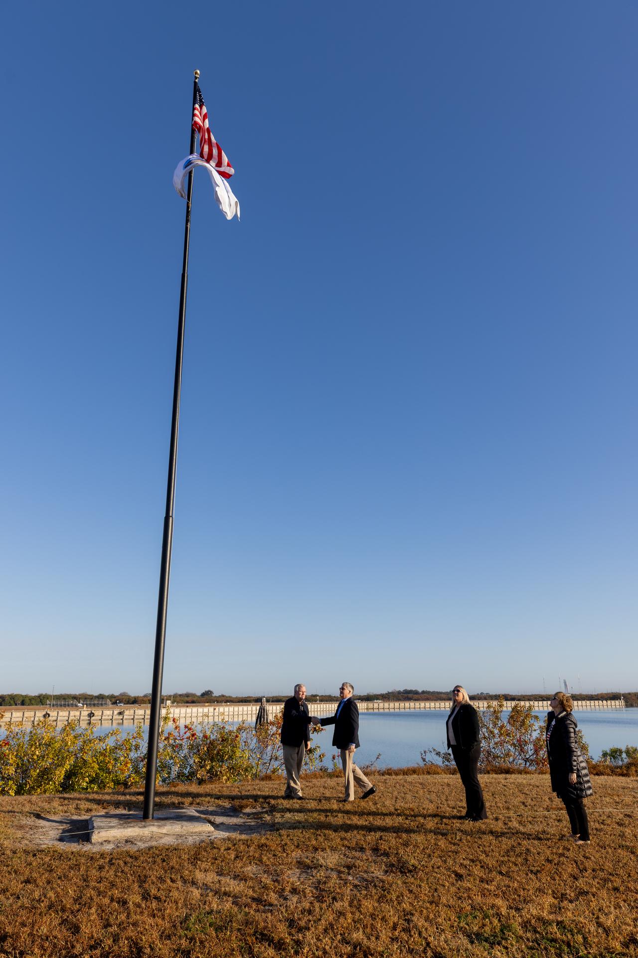 From left, Steve Sullivan, chief engineer to NASA’s Commercial Crew Program; Steve Stich, manager, Commercial Crew Program; Dana Hutcherson, deputy program manager, Commercial Crew Program; and Jackie Sullivan, participate in raising the agency’s SpaceX Crew-12 mission flag near the countdown clock at the NASA News Center at the agency’s Kennedy Space Center in Florida on Monday, Feb. 9, 2026. The Crew-12 mission will send NASA astronauts Jessica Meir and Jack Hathaway, ESA (European Space Agency) astronaut Sophie Adenot, and Roscosmos cosmonaut Andrey Fedyaev to the International Space Station aboard SpaceX’s Dragon spacecraft and Falcon 9 rocket no earlier than 5:38 a.m. EST, Thursday, Feb. 12, from Cape Canaveral Space Force Station’s Space Launch Complex 40.