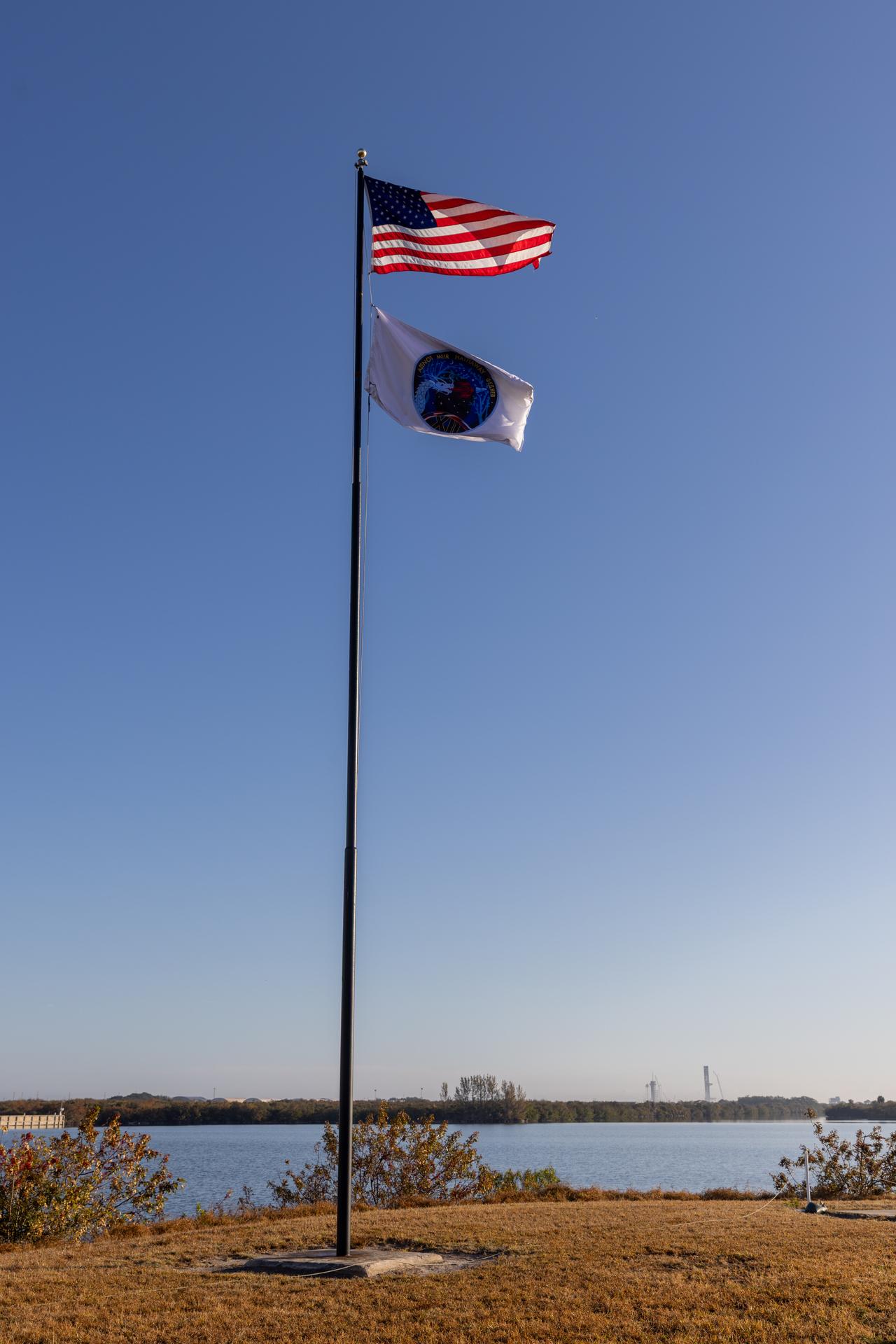 NASA Commercial Crew Program employees raise the agency’s SpaceX Crew-12 mission flag near the countdown clock at the NASA News Center at the agency’s Kennedy Space Center in Florida on Monday, Feb. 9, 2026. The Crew-12 mission will send NASA astronauts Jessica Meir and Jack Hathaway, ESA (European Space Agency) astronaut Sophie Adenot, and Roscosmos cosmonaut Andrey Fedyaev to the International Space Station aboard SpaceX’s Dragon spacecraft and Falcon 9 rocket no earlier than 5:38 a.m. EST, Thursday, Feb. 12, from Cape Canaveral Space Force Station’s Space Launch Complex 40.