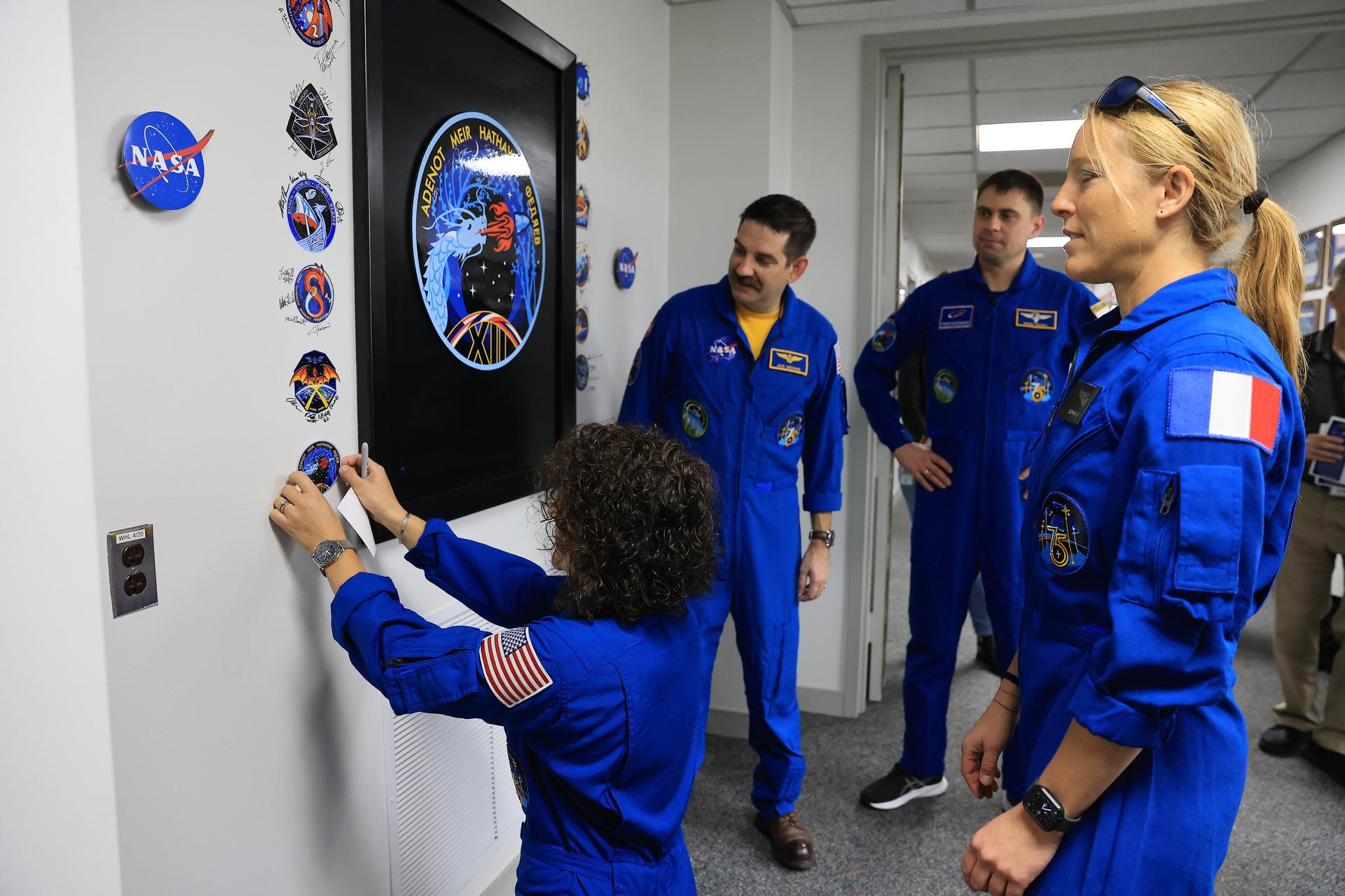From left, NASA astronauts Jessica Meir and Jack Hathaway, Roscosmos cosmonaut Andrey Fedyaev, and ESA (European Space Agency) astronaut Sophie Adenot attach their mission insignia to the wall inside the Astronaut Crew Quarters in the Neil A. Armstrong Operations and Checkout Building at NASA’s Kennedy Space Center in Florida on Monday, Feb. 9, 2026. NASA’s SpaceX Crew-12 crew members will launch aboard a SpaceX Dragon spacecraft and Falcon 9 to the International Space Station no earlier than 5:15 a.m. EST on Friday, Feb. 13, from Cape Canaveral Space Force Station’s Space Launch Complex 40.