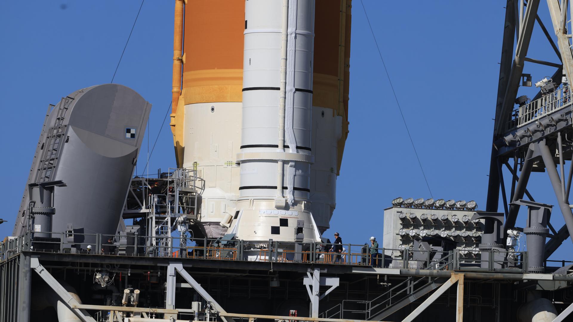 Two tail service masts, each about three stories tall, provide cryogenic propellant lines and electrical cable connections to NASA’s Artemis II SLS (Space Launch System) core stage rocket at Launch Complex 39B at NASA’s Kennedy Space Center in Florida on Tuesday, Feb. 10, 2026. The Artemis II test flight will take Commander Reid Wiseman, Pilot Victor Glover, and Mission Specialist Christina Koch from NASA, and Mission Specialist Jeremy Hansen from the CSA (Canadian Space Agency), around the Moon and back to Earth.
