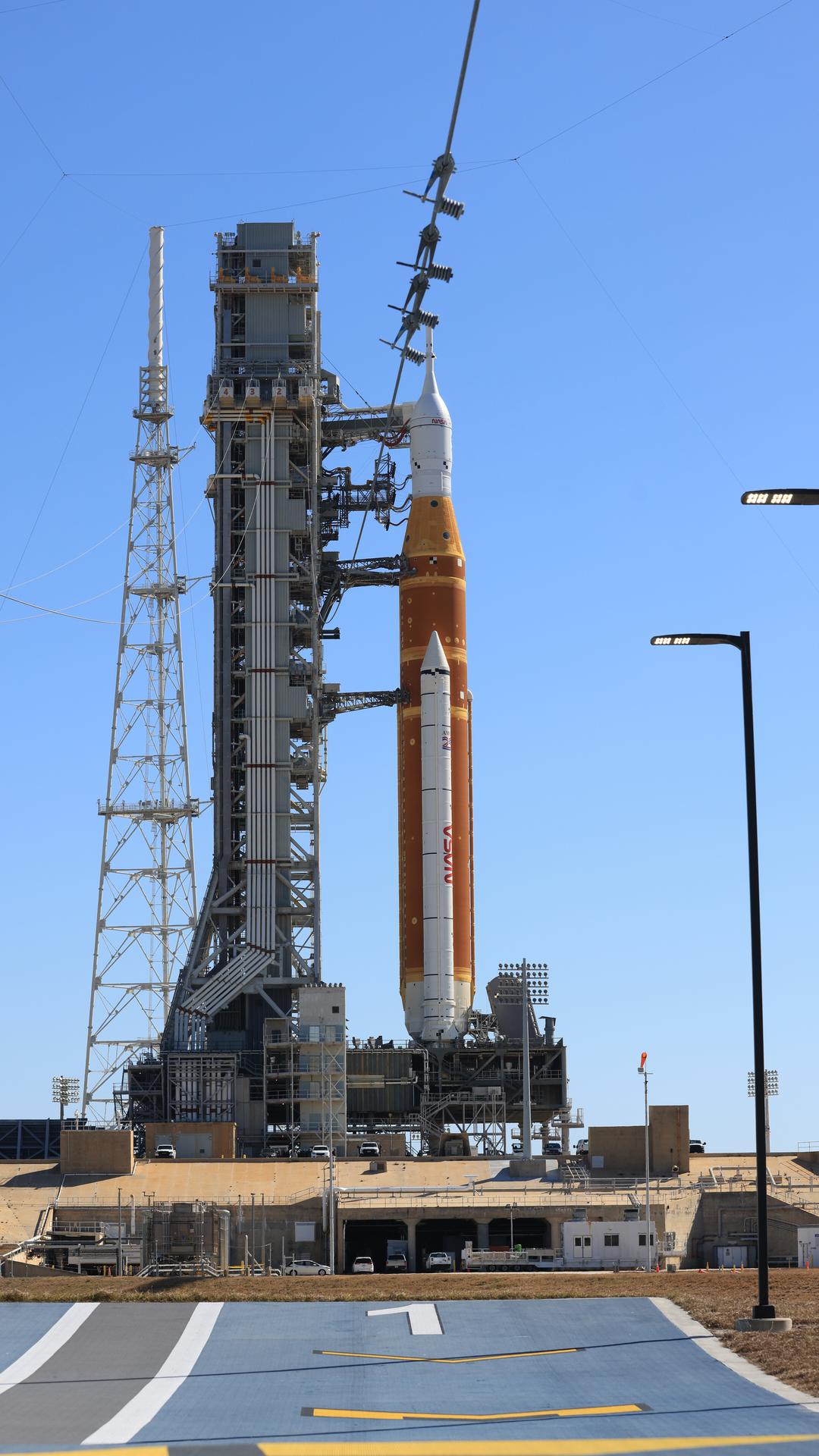 A side view shows one of the twin SLS (Space Launch System) solid rocket boosters, core stage, Orion spacecraft, and launch abort system of NASA’s Artemis II rocket at Launch Complex 39B at NASA’s Kennedy Space Center in Florida on Tuesday, Feb. 10, 2026. The Artemis II test flight will take Commander Reid Wiseman, Pilot Victor Glover, and Mission Specialist Christina Koch from NASA, and Mission Specialist Jeremy Hansen from the CSA (Canadian Space Agency), around the Moon and back to Earth.