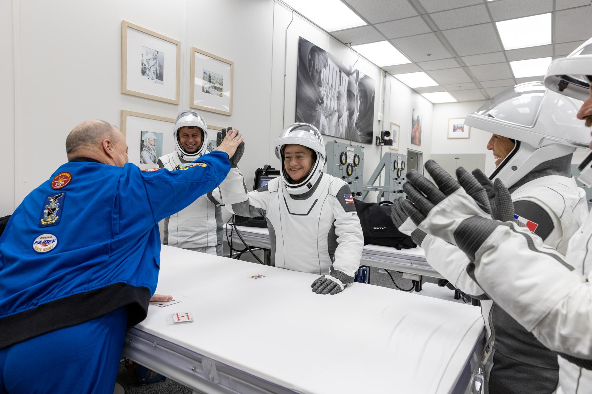 NASA astronaut Jessica Meir, commander of NASA’s SpaceX Crew-12 mission, high fives NASA astronaut Scott Tingle during the traditional prelaunch card game inside the Neil A. Armstrong Operations and Checkout Building at the agency’s Kennedy Space Center in Florida ahead of launch to the International Space Station on Friday, Feb. 13, 2026. Meir, NASA astronaut Jack Hathaway, ESA (European Space Agency) astronaut Sophie Adenot, and Roscosmos cosmonaut Andrey Fedyaev are scheduled to lift off aboard SpaceX’s Dragon spacecraft and Falcon 9 rocket at 5:15 a.m. EST, from Space Launch Complex 40 at Cape Canaveral Space Force Station in Florida.