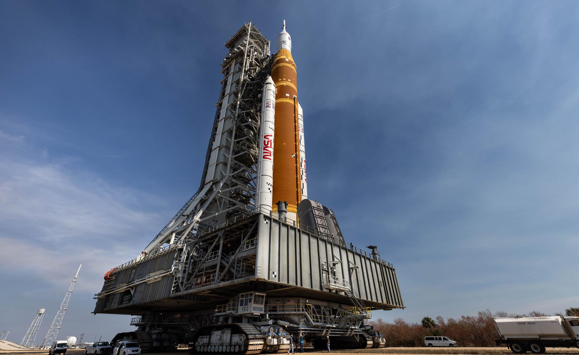 NASA’s crawler-transporter 2, carrying NASA’s Artemis II SLS (Space Launch System) rocket with the Orion spacecraft secured to mobile launcher 1, rolls back Wednesday, Feb. 25, 2026, to the Vehicle Assembly Building at NASA’s Kennedy Space Center in Florida to troubleshoot the flow of helium to the rocket’s upper stage, the interim cryogenic propulsion stage. Once complete, the SLS rocket will roll back to Launch Complex 39B to prepare to launch four astronauts around the Moon and back for the Artemis II test flight. 