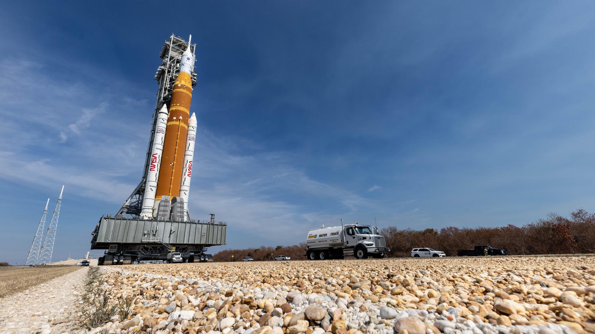 NASA’s crawler-transporter 2, carrying NASA’s Artemis II SLS (Space Launch System) rocket with the Orion spacecraft secured to mobile launcher 1, rolls back Wednesday, Feb. 25, 2026, to the Vehicle Assembly Building at NASA’s Kennedy Space Center in Florida to troubleshoot the flow of helium to the rocket’s upper stage, the interim cryogenic propulsion stage. Once complete, the SLS rocket will roll back to Launch Complex 39B to prepare to launch four astronauts around the Moon and back for the Artemis II test flight. 