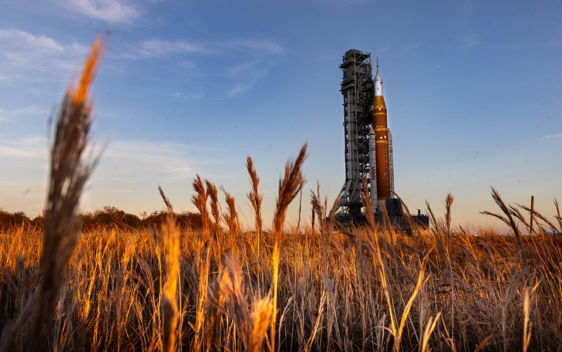 NASA’s crawler-transporter 2, carrying NASA’s Artemis II SLS (Space Launch System) rocket with the Orion spacecraft secured to mobile launcher 1, rolls back Wednesday, Feb. 25, 2026, to the Vehicle Assembly Building at NASA’s Kennedy Space Center in Florida to troubleshoot the flow of helium to the rocket’s upper stage, the interim cryogenic propulsion stage. Once complete, the SLS rocket will roll back to Launch Complex 39B to prepare to launch four astronauts around the Moon and back for the Artemis II test flight. 