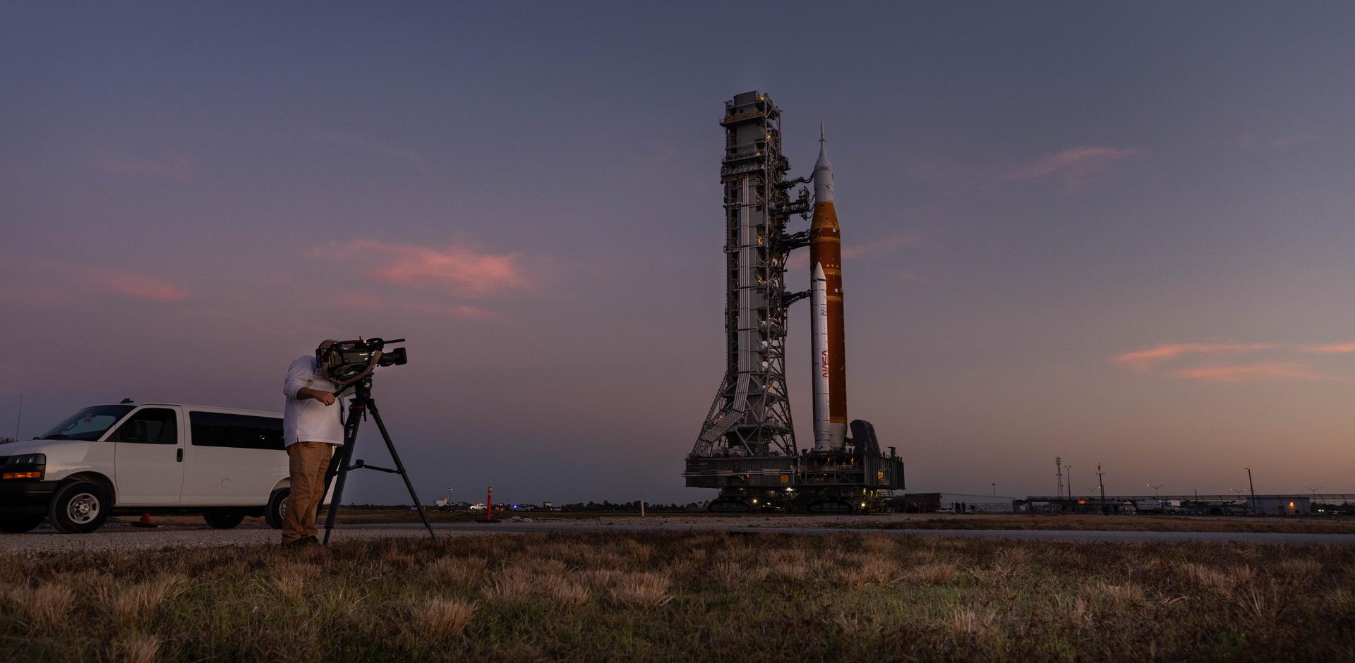 NASA’s crawler-transporter 2, carrying NASA’s Artemis II SLS (Space Launch System) rocket with the Orion spacecraft secured to mobile launcher 1, rolls back Wednesday, Feb. 25, 2026, to the Vehicle Assembly Building at NASA’s Kennedy Space Center in Florida to troubleshoot the flow of helium to the rocket’s upper stage, the interim cryogenic propulsion stage. Once complete, the SLS rocket will roll back to Launch Complex 39B to prepare to launch four astronauts around the Moon and back for the Artemis II test flight. 