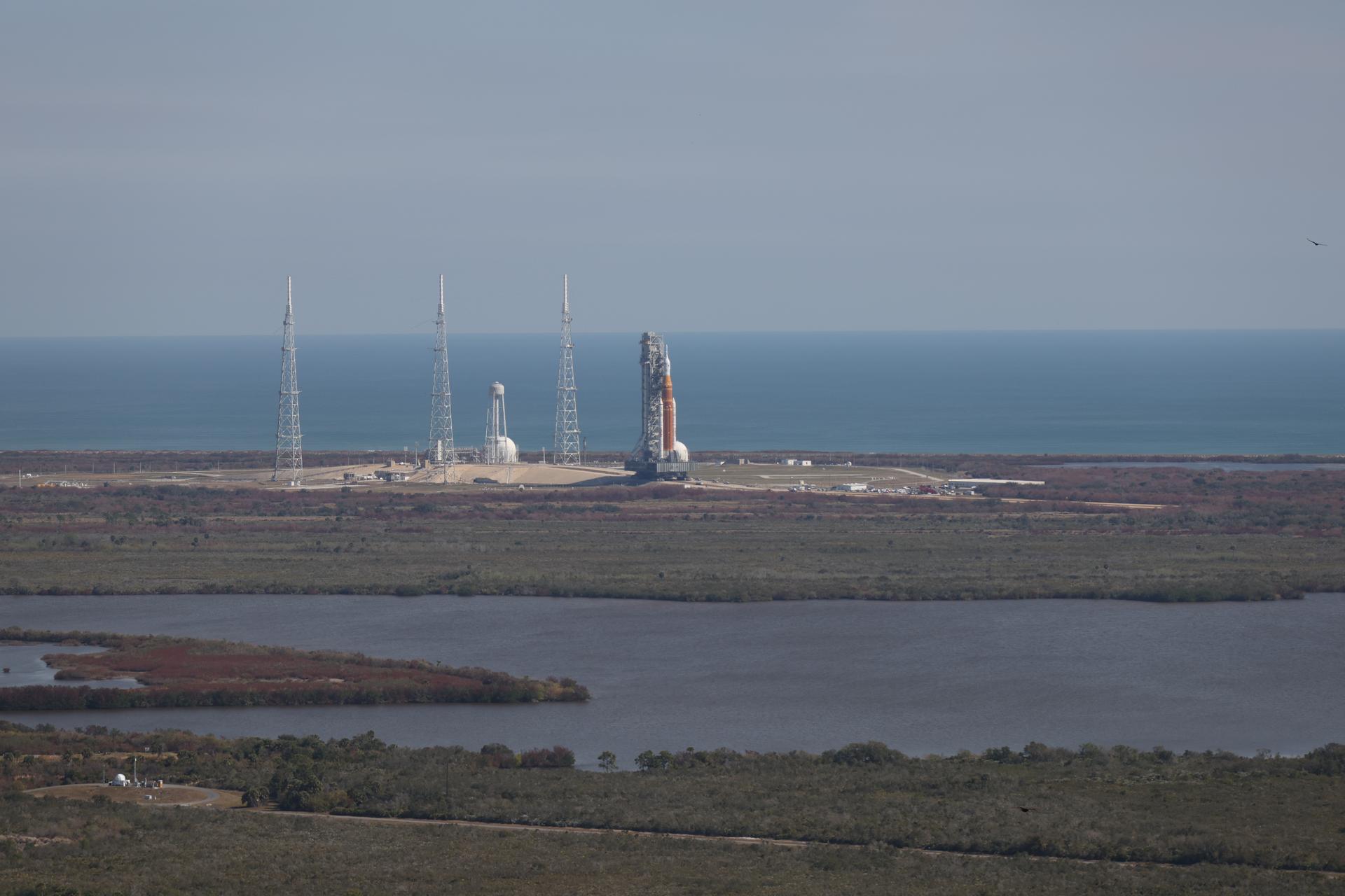 NASA’s crawler-transporter 2, carrying NASA’s Artemis II SLS (Space Launch System) rocket with the Orion spacecraft secured to mobile launcher 1, leaves Launch Complex 39B to roll back to the Vehicle Assembly Building at NASA’s Kennedy Space Center in Florida on Wednesday, Feb. 25, 2026, to troubleshoot the flow of helium to the rocket’s upper stage, the interim cryogenic propulsion stage. Once complete, the SLS rocket will roll back to Launch Complex 39B to prepare to launch four astronauts around the Moon and back for the Artemis II test flight. 