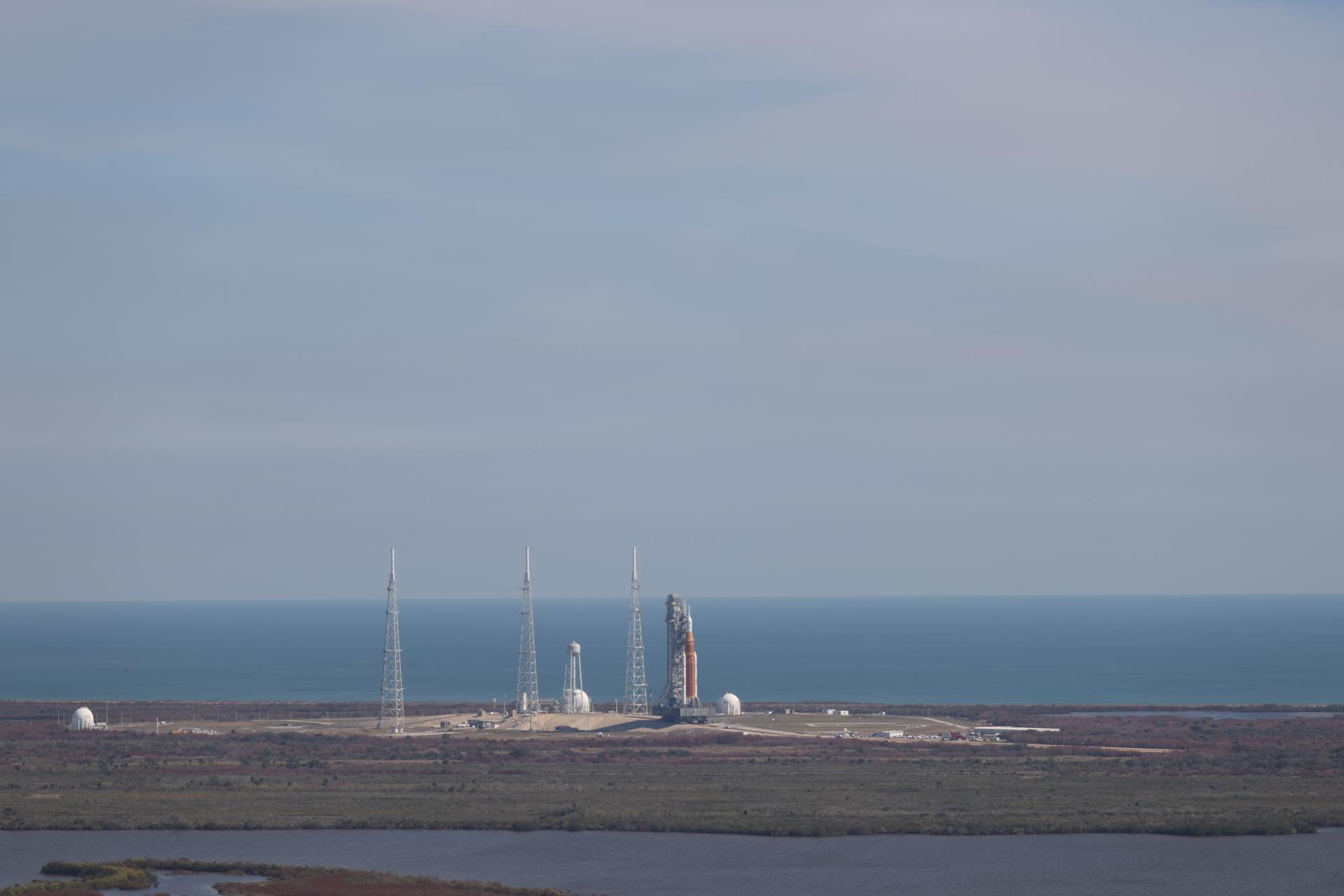 NASA’s crawler-transporter 2, carrying NASA’s Artemis II SLS (Space Launch System) rocket with the Orion spacecraft secured to mobile launcher 1, leaves Launch Complex 39B to roll back to the Vehicle Assembly Building at NASA’s Kennedy Space Center in Florida on Wednesday, Feb. 25, 2026, to troubleshoot the flow of helium to the rocket’s upper stage, the interim cryogenic propulsion stage. Once complete, the SLS rocket will roll back to Launch Complex 39B to prepare to launch four astronauts around the Moon and back for the Artemis II test flight. 