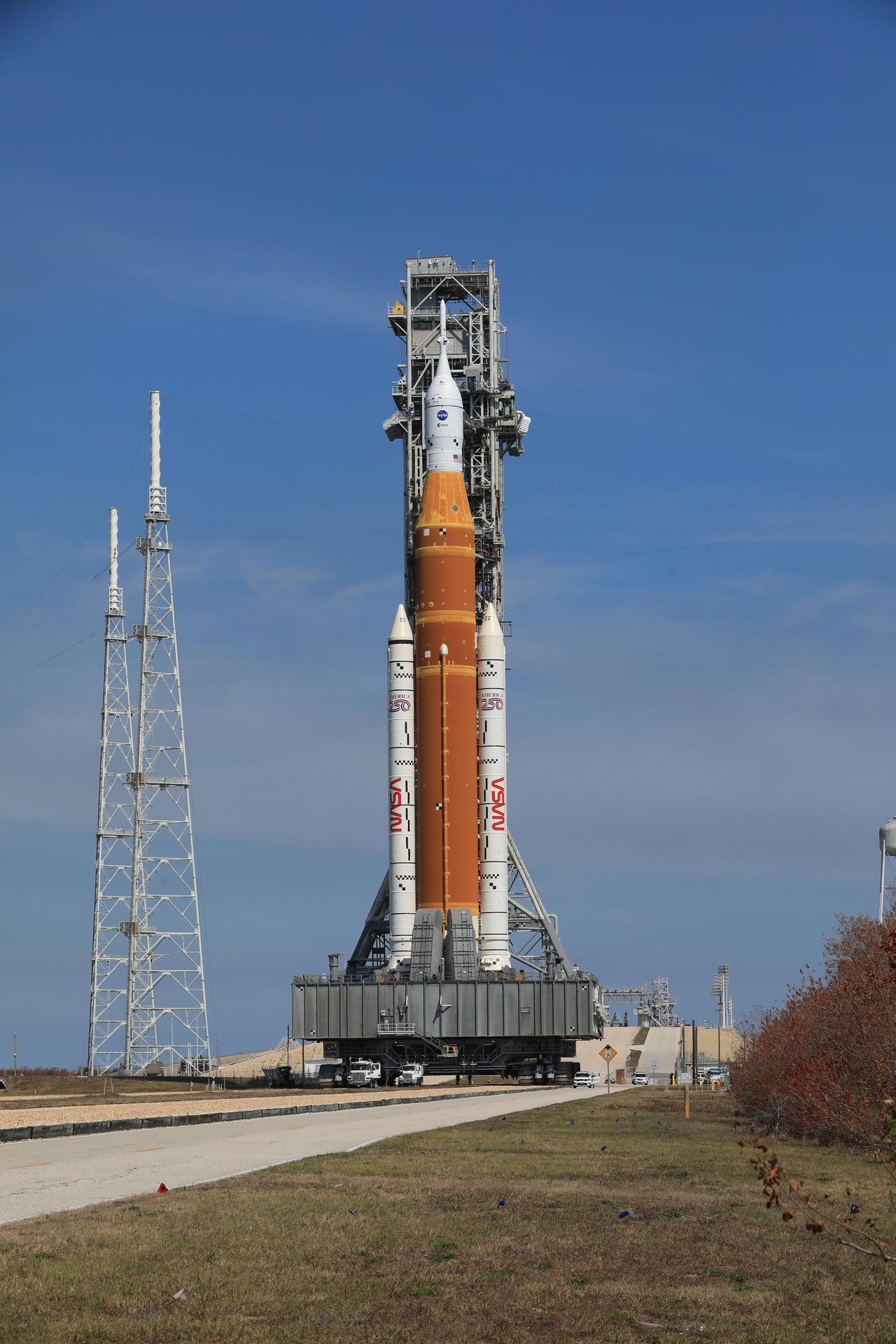 NASA’s crawler-transporter 2, carrying NASA’s Artemis II SLS (Space Launch System) rocket with the Orion spacecraft secured to mobile launcher 1, leaves Launch Complex 39B to roll back to the Vehicle Assembly Building at NASA’s Kennedy Space Center in Florida on Wednesday, Feb. 25, 2026, to troubleshoot the flow of helium to the rocket’s upper stage, the interim cryogenic propulsion stage. Once complete, the SLS rocket will roll back to Launch Complex 39B to prepare to launch four astronauts around the Moon and back for the Artemis II test flight. 