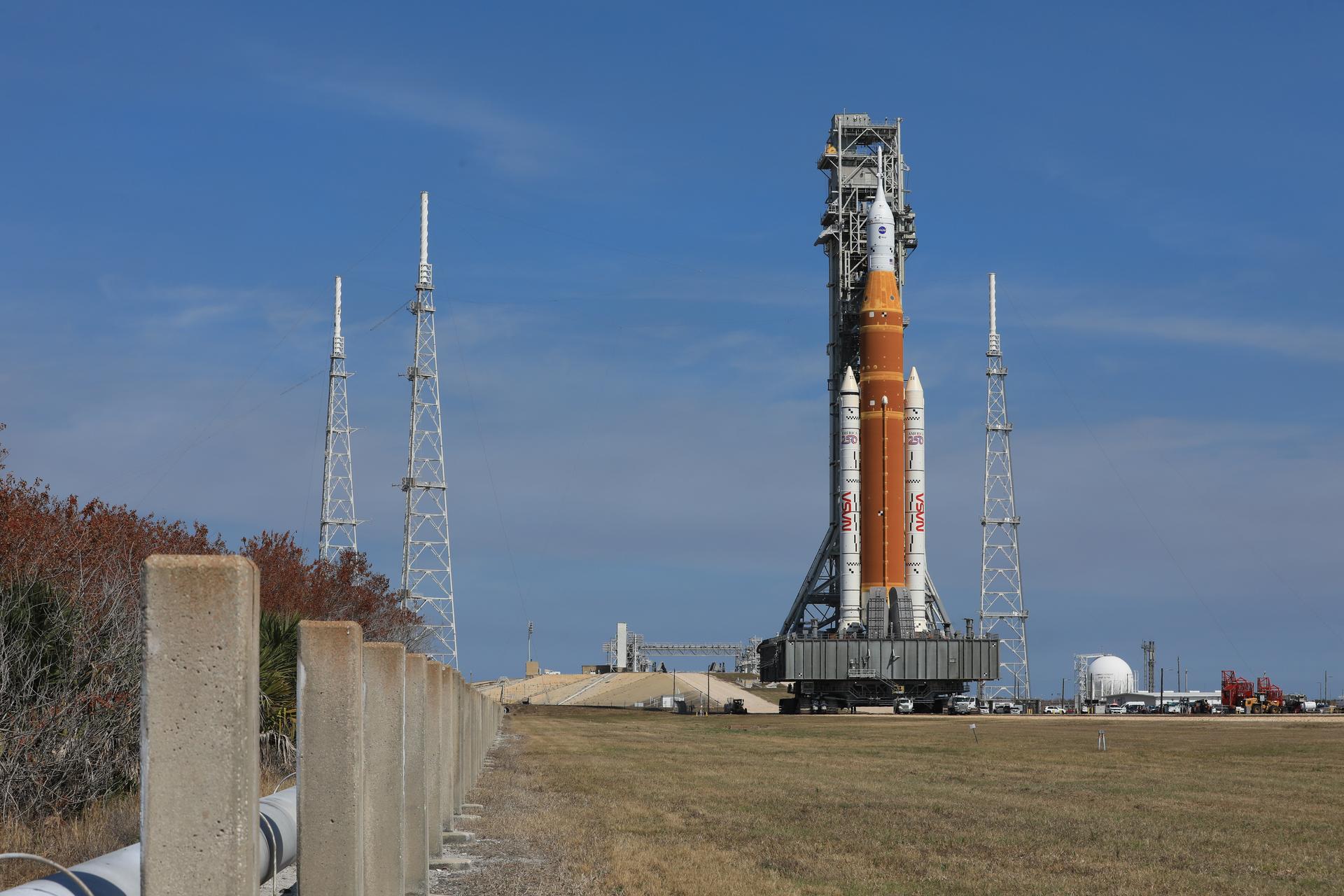 NASA’s crawler-transporter 2, carrying NASA’s Artemis II SLS (Space Launch System) rocket with the Orion spacecraft secured to mobile launcher 1, rolls back Wednesday, Feb. 25, 2026, to the Vehicle Assembly Building at NASA’s Kennedy Space Center in Florida to troubleshoot the flow of helium to the rocket’s upper stage, the interim cryogenic propulsion stage. Once complete, the SLS rocket will roll back to Launch Complex 39B to prepare to launch four astronauts around the Moon and back for the Artemis II test flight. 