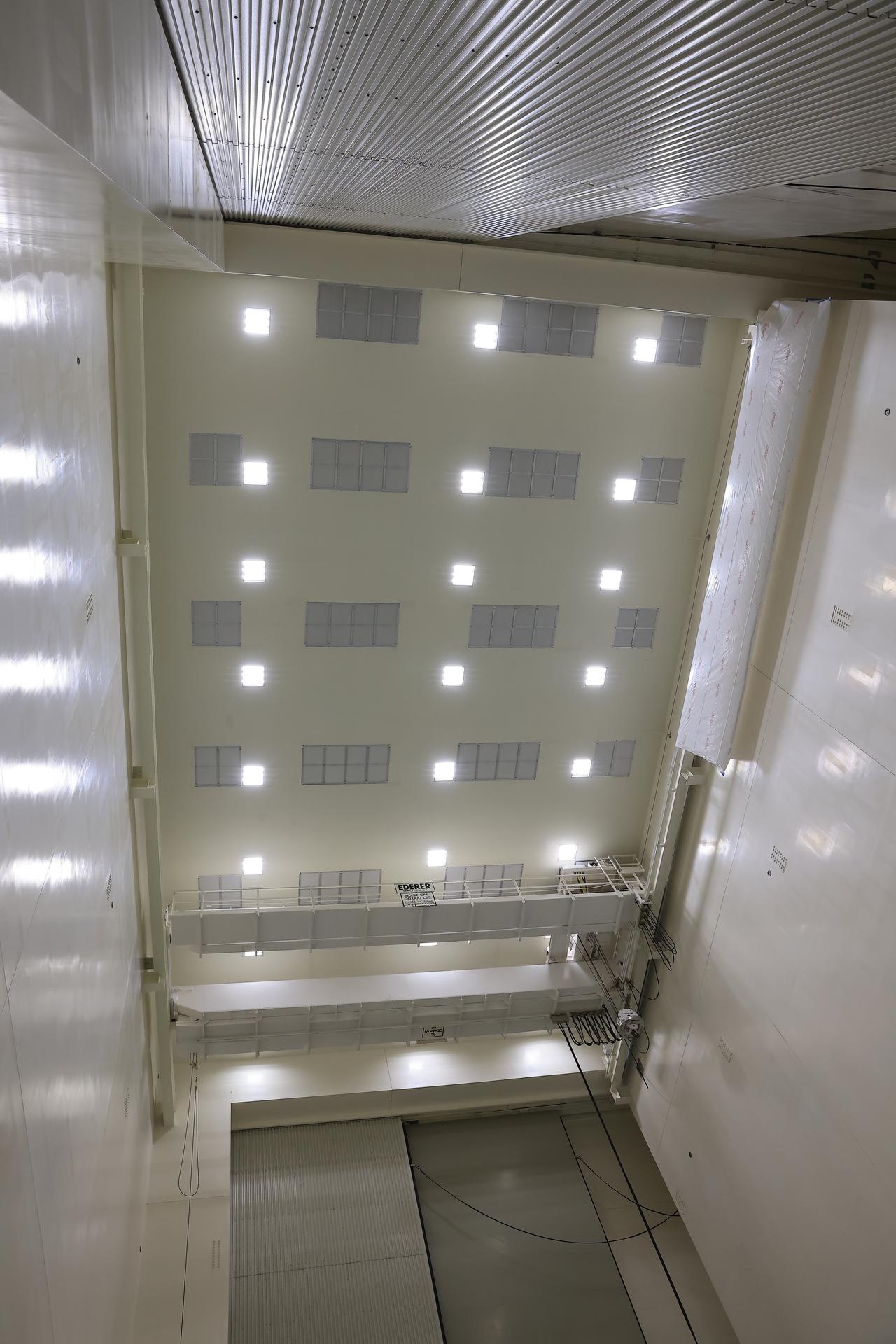 This photograph shows a newly repainted crane mounted inside NASA’s Payload Hazardous Servicing Facility on Friday, Feb. 27, 2026, preparations for the arrival of the agency’s Nancy Grace Roman Space Telescope to NASA’s Kennedy Space Center in Florida. Workers repainted the facility’s 15-ton bridge crane to prevent any paint chips from becoming foreign object debris. The Roman space telescope will provide deep, panoramic views of the cosmos, generating never-before-seen pictures that will revolutionize our understanding of the universe. Roman will undergo several prelaunch operations, including thermal protection closeout, cleaning, solar array work, and loading hydrazine propellant. 