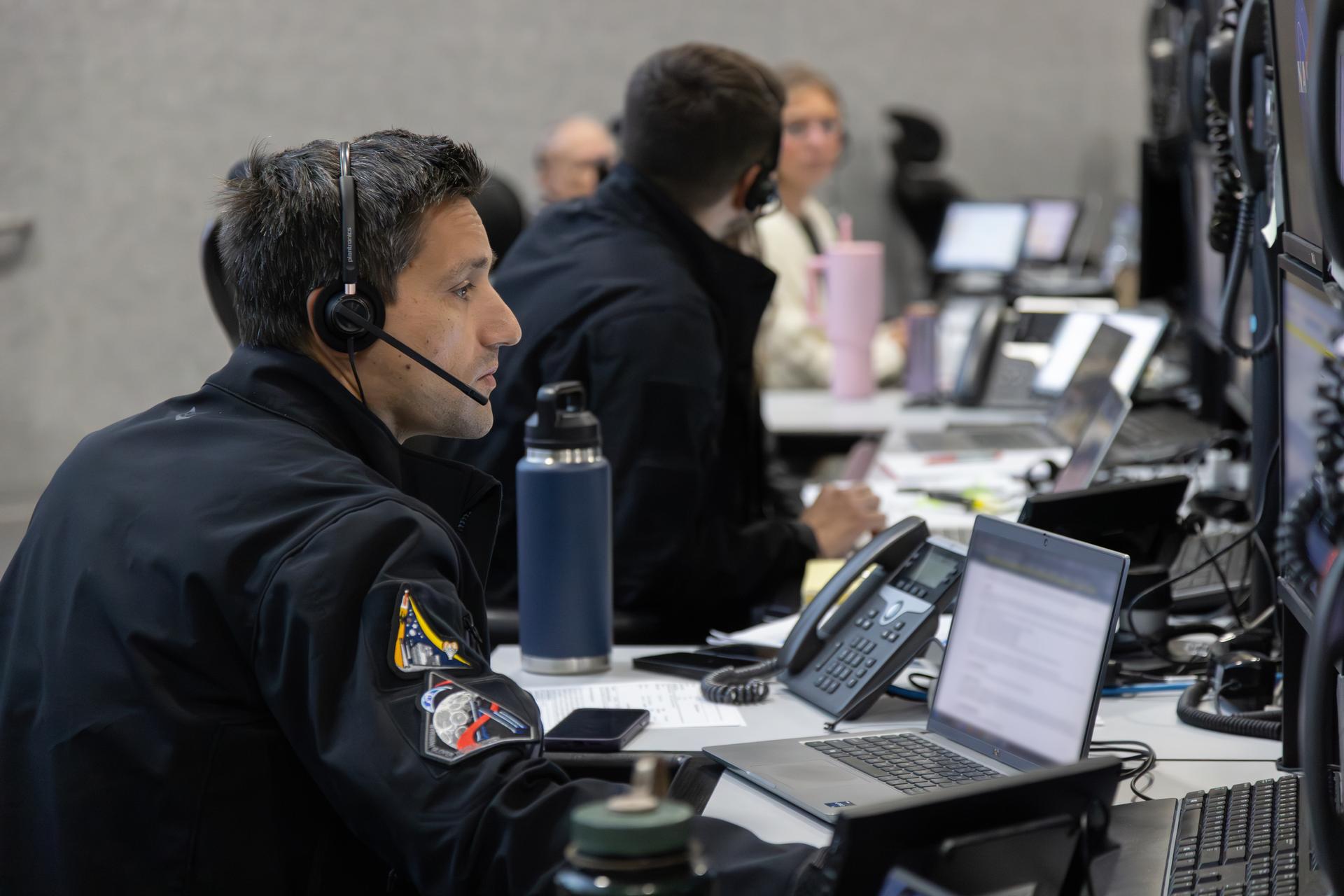 An Artemis launch team member, seen inside Firing Room 1 of the Rocco A. Petrone Launch Control Center, participates in the rollout of the Artemis II SLS (Space Launch System) rocket and Orion spacecraft from the Vehicle Assembly Building to Launch Complex 39B at NASA’s Kennedy Space Center in Florida on Friday, March 20, 2026. The Artemis II test flight will take Commander Reid Wiseman, Pilot Victor Glover, and Mission Specialist Christina Koch from NASA, and Mission Specialist Jeremy Hansen from the CSA (Canadian Space Agency), around the Moon and back to Earth with launch opportunities beginning in April 2026.
