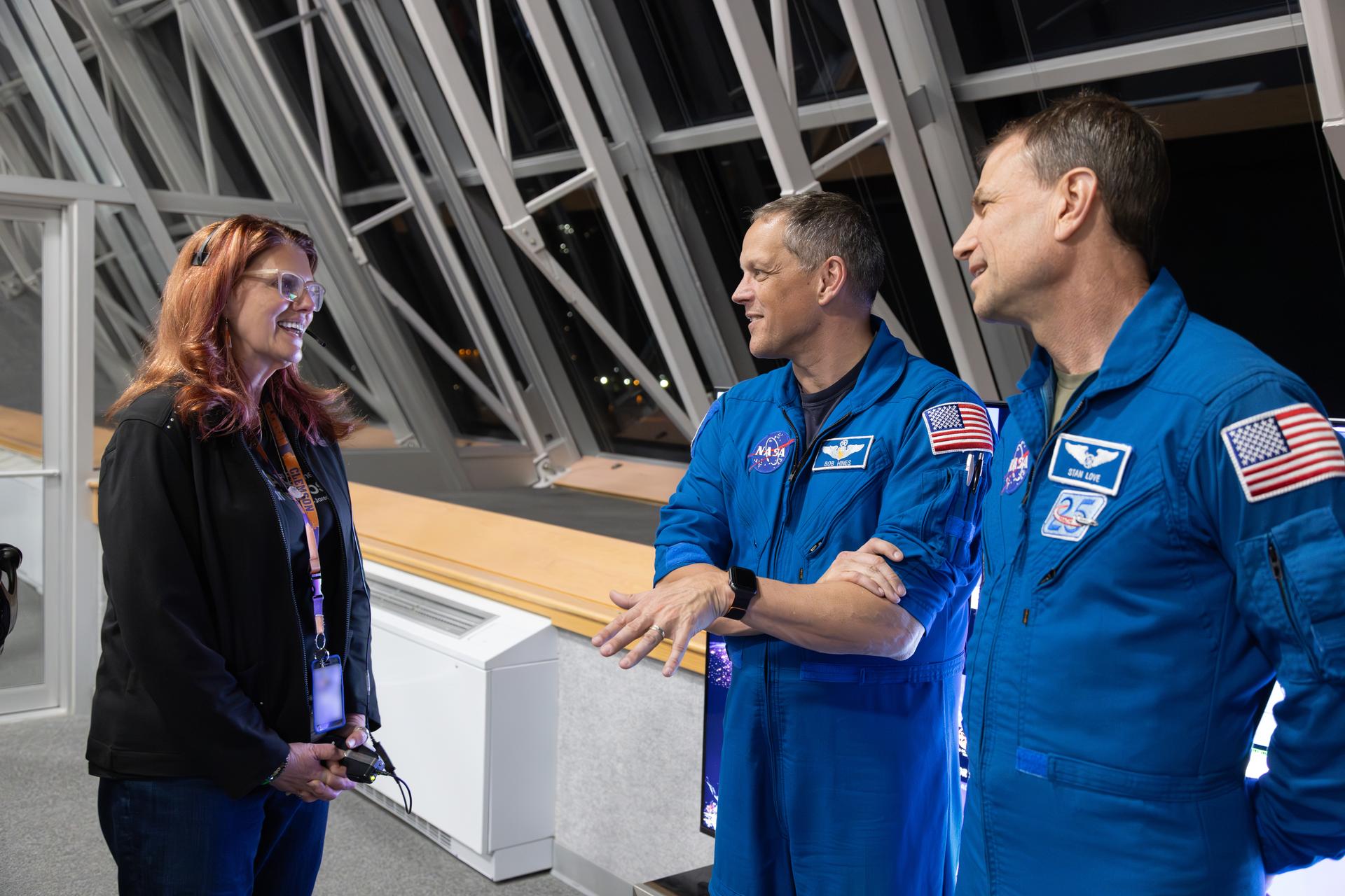 From left, Charlie Blackwell-Thompson, Artemis launch director, NASA’s Exploration Ground Systems Program, talks to NASA astronauts Bob Hines and Stan Love inside Firing Room 1 of the Rocco A. Petrone Launch Control Center during the Artemis II rollout of the SLS (Space Launch System) rocket and Orion spacecraft from the Vehicle Assembly Building to Launch Complex 39B at NASA’s Kennedy Space Center in Florida on Friday, March 20, 2026. The Artemis II test flight will take Commander Reid Wiseman, Pilot Victor Glover, and Mission Specialist Christina Koch from NASA, and Mission Specialist Jeremy Hansen from the CSA (Canadian Space Agency), around the Moon and back to Earth with launch opportunities beginning in April 2026.