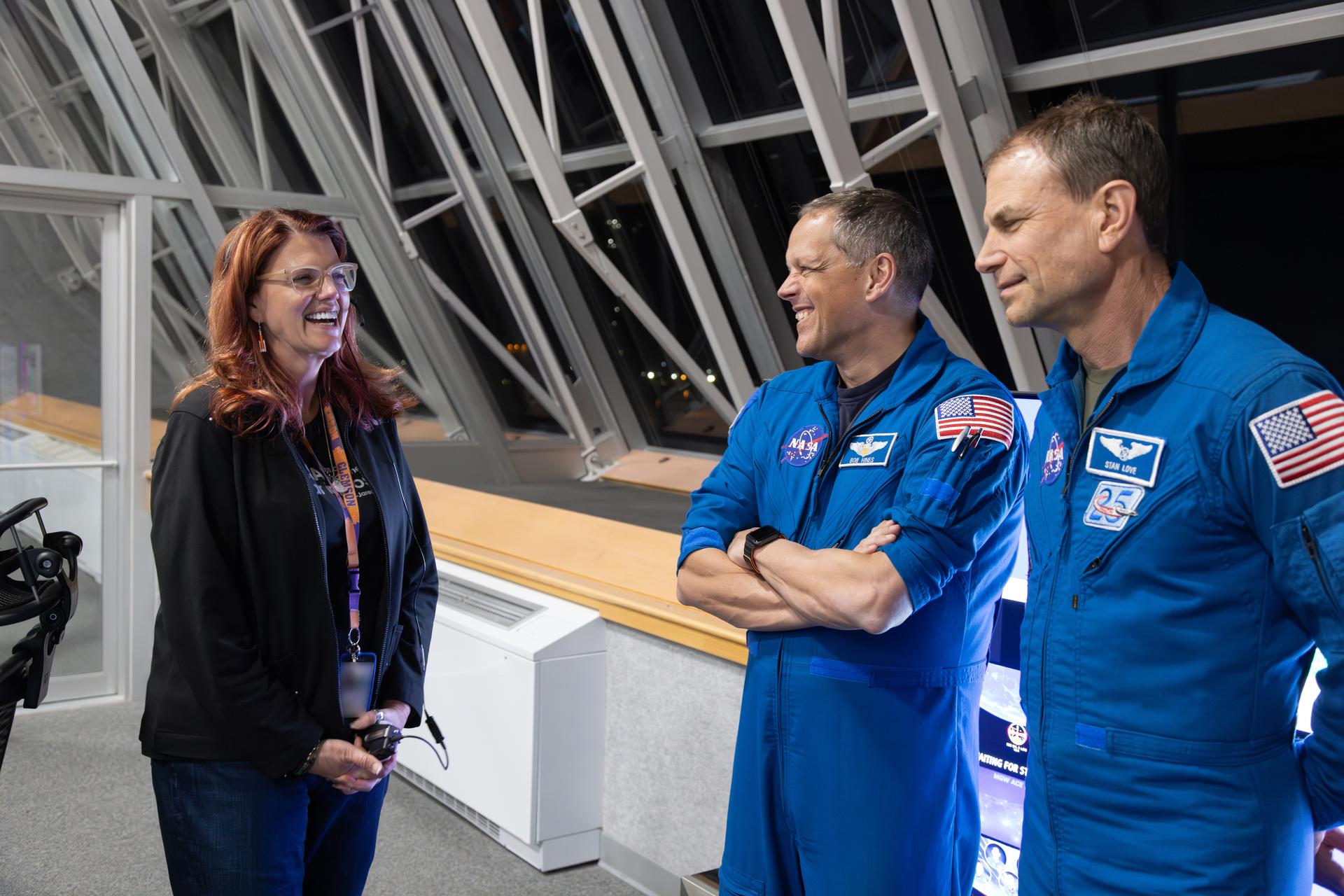 From left, Charlie Blackwell-Thompson, Artemis launch director, NASA’s Exploration Ground Systems Program, talks to NASA astronauts Bob Hines and Stan Love inside Firing Room 1 of the Rocco A. Petrone Launch Control Center during the Artemis II rollout of the SLS (Space Launch System) rocket and Orion spacecraft from the Vehicle Assembly Building to Launch Complex 39B at NASA’s Kennedy Space Center in Florida on Friday, March 20, 2026. The Artemis II test flight will take Commander Reid Wiseman, Pilot Victor Glover, and Mission Specialist Christina Koch from NASA, and Mission Specialist Jeremy Hansen from the CSA (Canadian Space Agency), around the Moon and back to Earth with launch opportunities beginning in April 2026.