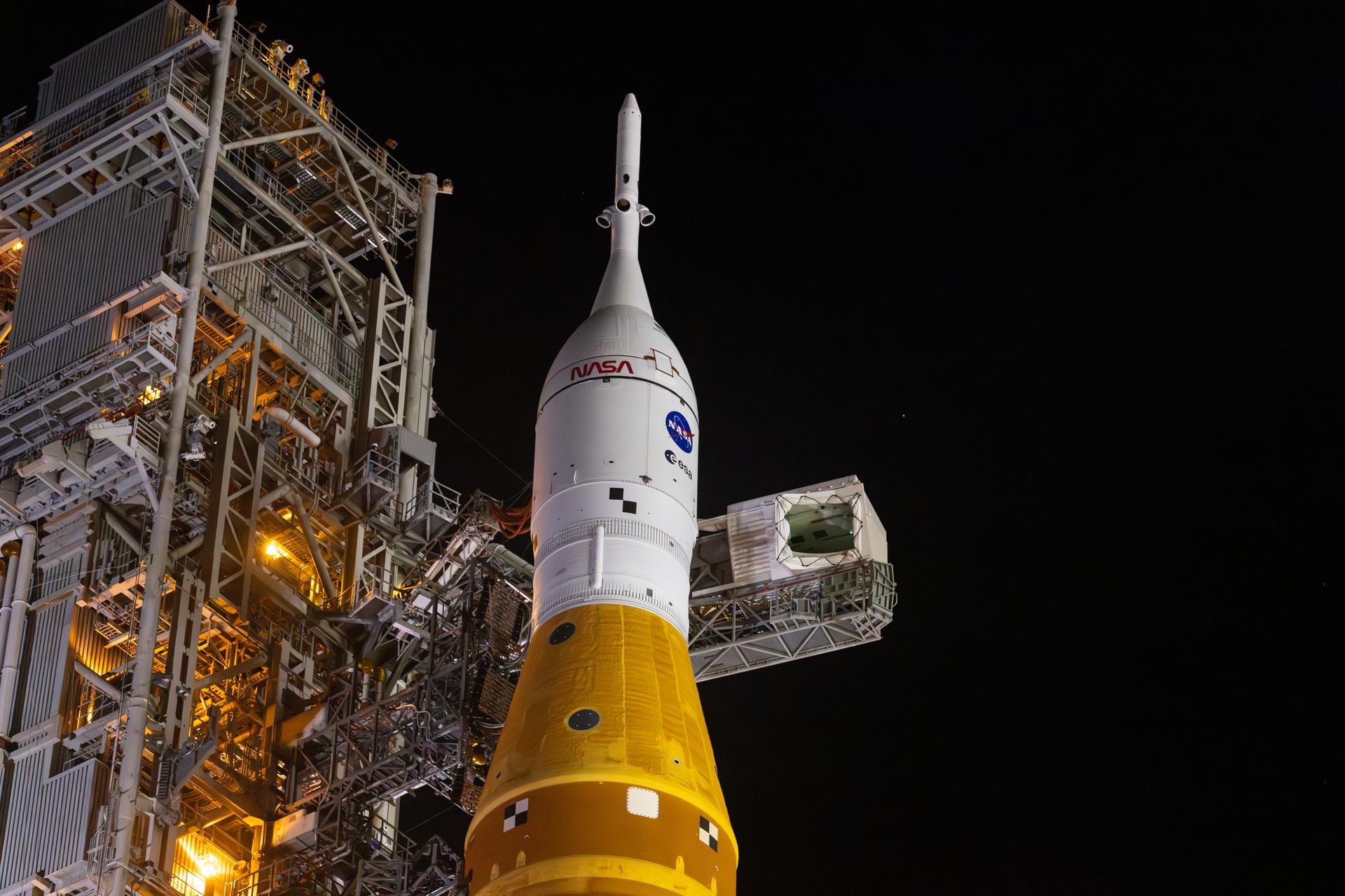 A closeup view of NASA’s Orion spacecraft with the launch abort system atop secured to NASA’s crawler-transporter 2 and the agency’s Artemis II SLS (Space Launch System) rocket begins the 4-mile journey toward Launch Complex 39B at NASA’s Kennedy Space Center in Florida on Friday, March 20, 2026. The Artemis II test flight will take Commander Reid Wiseman, Pilot Victor Glover, and Mission Specialist Christina Koch from NASA, and Mission Specialist Jeremy Hansen from the CSA (Canadian Space Agency), around the Moon and back to Earth with launch opportunities beginning in April 2026.