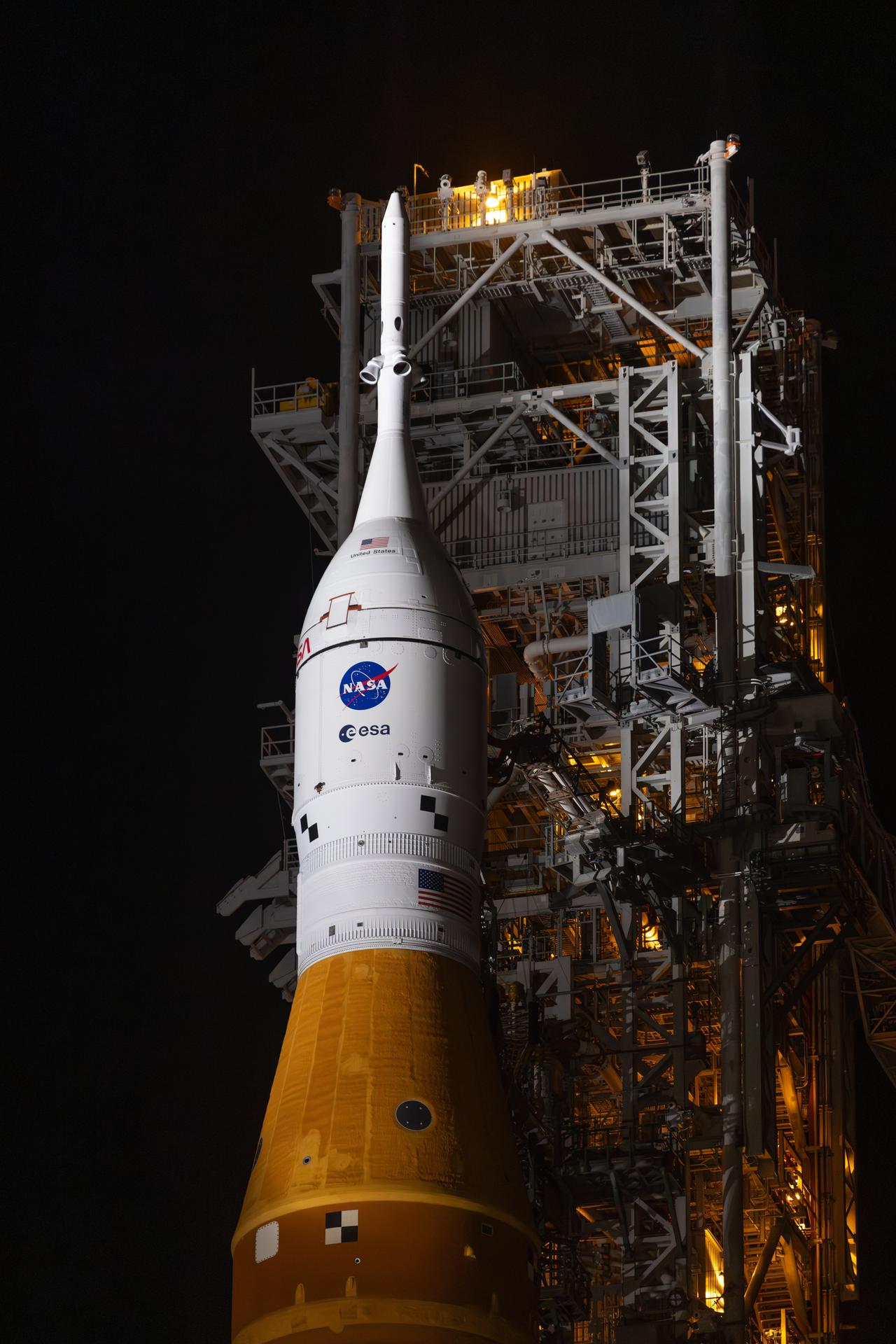A closeup view of NASA’s Orion spacecraft with the launch abort system atop secured to NASA’s crawler-transporter 2 and the agency’s Artemis II SLS (Space Launch System) rocket begins the 4-mile journey from the Vehicle Assembly Building toward Launch Complex 39B at NASA’s Kennedy Space Center in Florida on Friday, March 20, 2026. The Artemis II test flight will take Commander Reid Wiseman, Pilot Victor Glover, and Mission Specialist Christina Koch from NASA, and Mission Specialist Jeremy Hansen from the CSA (Canadian Space Agency), around the Moon and back to Earth with launch opportunities beginning in April 2026.