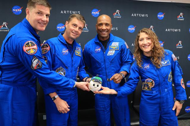 The Artemis II crew pose with the zero gravity indicator named Rise that also...