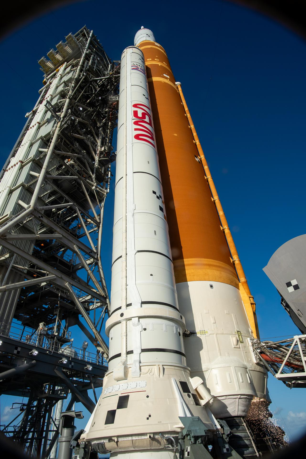 In this photograph looking up, NASA’s SLS (Space Launch System) rocket with the Orion spacecraft stands vertical at Launch Complex 39B at NASA’s Kennedy Space Center in Florida ahead of launch of the agency’s Artemis II test flight on Wednesday, April 1, 2026. Artemis II launched at 6:35 p.m. EDT April 1 at NASA Kennedy, sending Artemis II Commander Reid Wiseman, Pilot Victor Glover, and Mission Specialist Christina Koch from NASA, along with Mission Specialist Jeremy Hansen from the CSA (Canadian Space Agency), on a 10-day journey around the Moon and back with splashdown in the Pacific Ocean off the coast of San Diego, California on Friday, April 10.