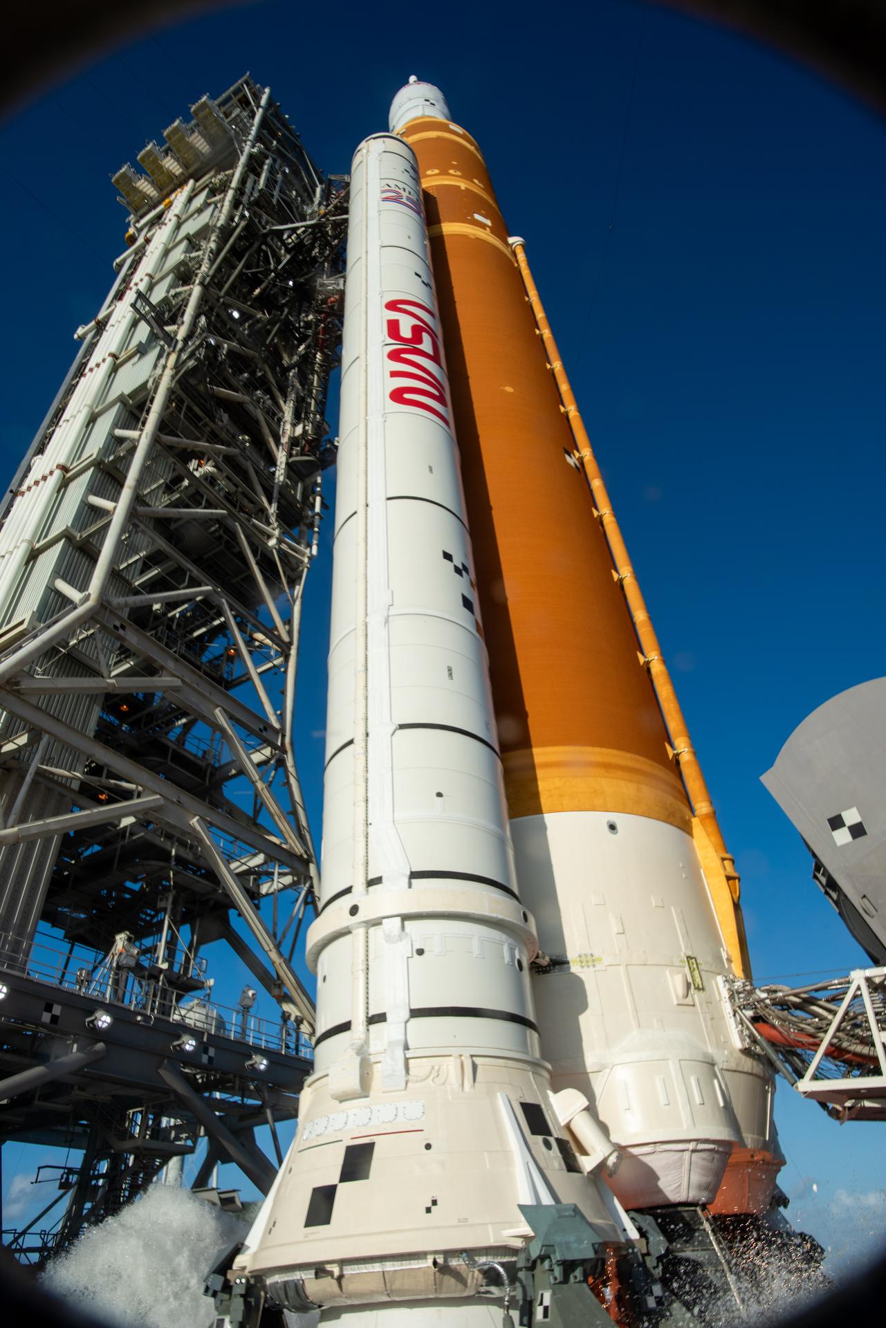 In this photograph looking up, NASA’s SLS (Space Launch System) rocket with the Orion spacecraft stands vertical at Launch Complex 39B at NASA’s Kennedy Space Center in Florida ahead of launch of the agency’s Artemis II test flight on Wednesday, April 1, 2026. Artemis II launched at 6:35 p.m. EDT April 1 at NASA Kennedy, sending Artemis II Commander Reid Wiseman, Pilot Victor Glover, and Mission Specialist Christina Koch from NASA, along with Mission Specialist Jeremy Hansen from the CSA (Canadian Space Agency), on a 10-day journey around the Moon and back with splashdown in the Pacific Ocean off the coast of San Diego, California on Friday, April 10.