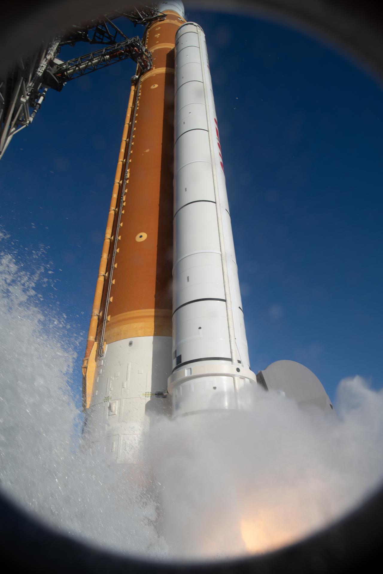 The Ignition Overpressure Protection and Sound Suppression water deluge system activates during launch of NASA’s Artemis II test flight at Launch Complex 39B at NASA’s Kennedy Space Center in Florida at 6:35 p.m. EDT on Wednesday, April 1, 2026. The water deluge system releases about 450,000 gallons of water across the mobile launcher and flame deflector to reduce the extreme heat and energy generated by the rocket during ignition and liftoff. Artemis II Commander Reid Wiseman, Pilot Victor Glover, and Mission Specialist Christina Koch from NASA, along with Mission Specialist Jeremy Hansen from the CSA (Canadian Space Agency), are on a 10-day journey around the Moon and back with splashdown in the Pacific Ocean off the coast of San Diego, California on Friday, April 10.