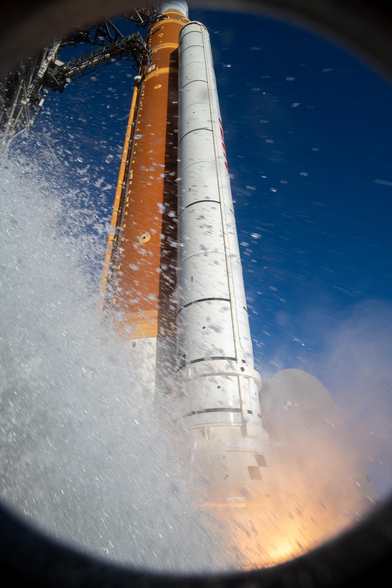 The Ignition Overpressure Protection and Sound Suppression water deluge system activates during launch of NASA’s Artemis II test flight at Launch Complex 39B at NASA’s Kennedy Space Center in Florida at 6:35 p.m. EDT on Wednesday, April 1, 2026. The water deluge system releases about 450,000 gallons of water across the mobile launcher and flame deflector to reduce the extreme heat and energy generated by the rocket during ignition and liftoff. Artemis II Commander Reid Wiseman, Pilot Victor Glover, and Mission Specialist Christina Koch from NASA, along with Mission Specialist Jeremy Hansen from the CSA (Canadian Space Agency), are on a 10-day journey around the Moon and back with splashdown in the Pacific Ocean off the coast of San Diego, California on Friday, April 10.