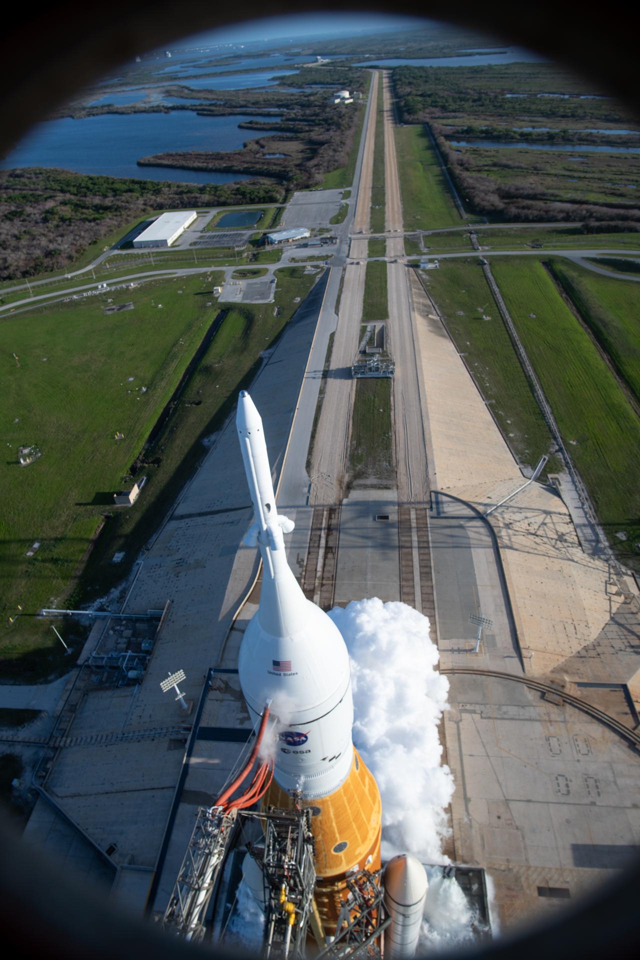 In this photograph looking down, NASA’s SLS (Space Launch System) rocket with the Orion spacecraft carrying Artemis II Commander Reid Wiseman, Pilot Victor Glover, and Mission Specialist Christina Koch from NASA, along with Mission Specialist Jeremy Hansen from the CSA (Canadian Space Agency), lifts off at 6:35 p.m. EDT on Wednesday, April 1, 2026, from Launch Complex 39B at NASA’s Kennedy Space Center I Florida. The Artemis II test flight will take the crew members on a 10-day journey around the Moon and back on Friday, April 10. 