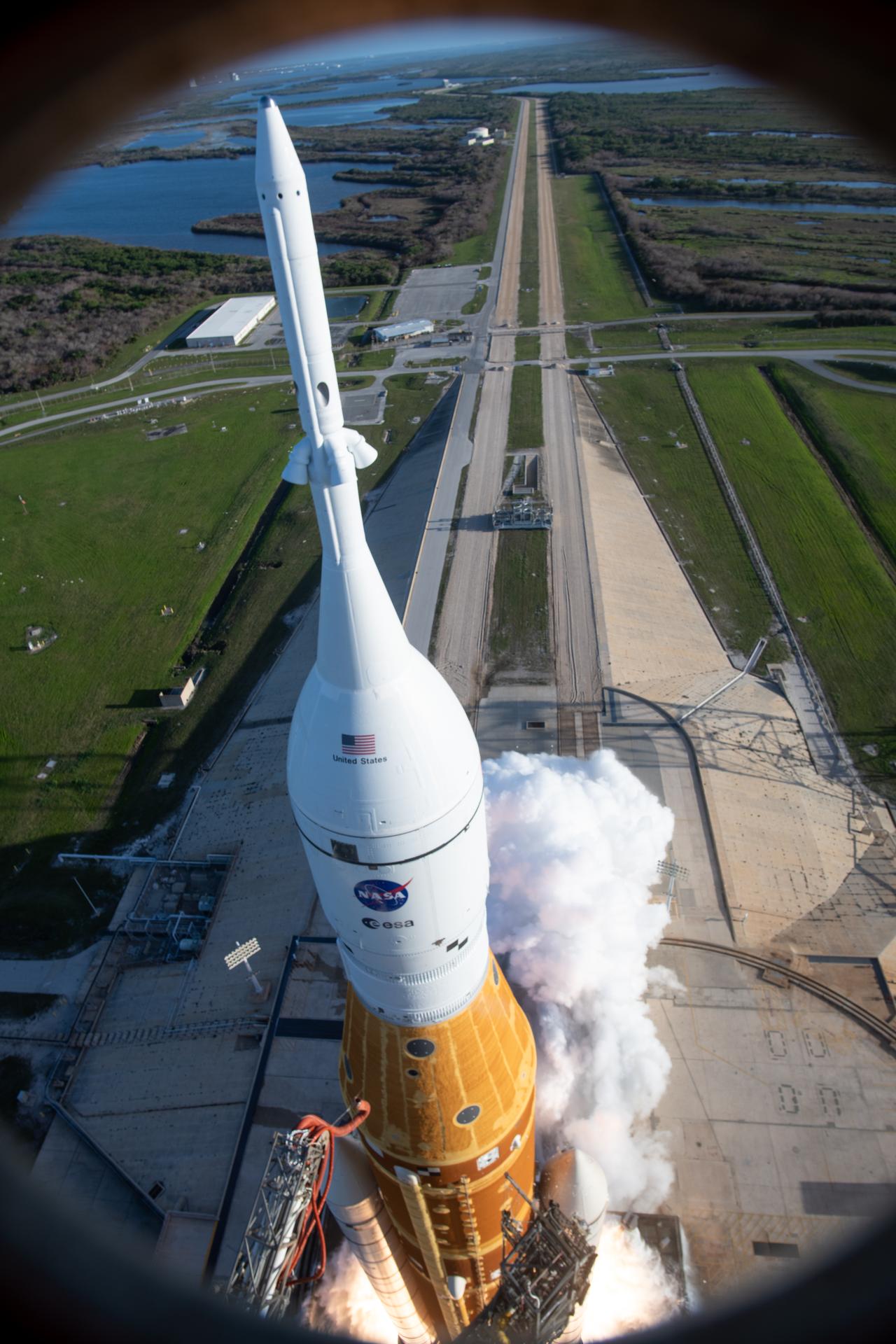 In this photograph looking down, NASA’s SLS (Space Launch System) rocket with the Orion spacecraft carrying Artemis II Commander Reid Wiseman, Pilot Victor Glover, and Mission Specialist Christina Koch from NASA, along with Mission Specialist Jeremy Hansen from the CSA (Canadian Space Agency), lifts off at 6:35 p.m. EDT on Wednesday, April 1, 2026, from Launch Complex 39B at NASA’s Kennedy Space Center I Florida. The Artemis II test flight will take the crew members on a 10-day journey around the Moon and back on Friday, April 10. 