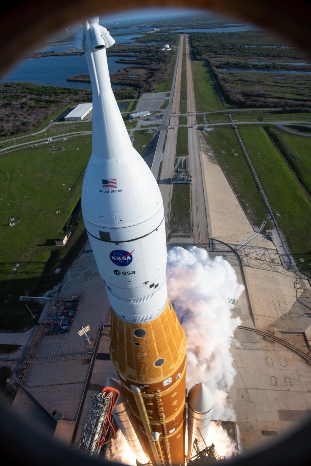 In this photograph looking down, NASA’s SLS (Space Launch System) rocket with the Orion spacecraft carrying Artemis II Commander Reid Wiseman, Pilot Victor Glover, and Mission Specialist Christina Koch from NASA, along with Mission Specialist Jeremy Hansen from the CSA (Canadian Space Agency), lifts off at 6:35 p.m. EDT on Wednesday, April 1, 2026, from Launch Complex 39B at NASA’s Kennedy Space Center I Florida. The Artemis II test flight will take the crew members on a 10-day journey around the Moon and back on Friday, April 10. 