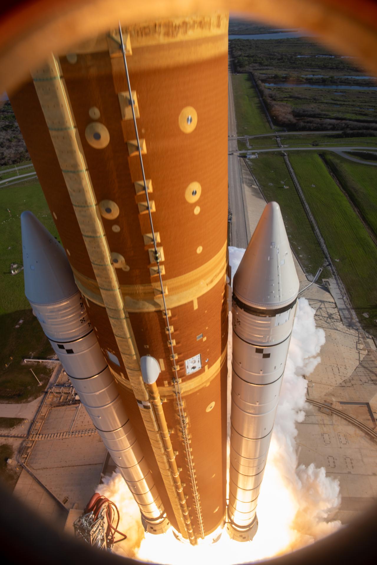 In this photograph looking down, NASA’s SLS (Space Launch System) rocket with the Orion spacecraft carrying Artemis II Commander Reid Wiseman, Pilot Victor Glover, and Mission Specialist Christina Koch from NASA, along with Mission Specialist Jeremy Hansen from the CSA (Canadian Space Agency), lifts off at 6:35 p.m. EDT on Wednesday, April 1, 2026, from Launch Complex 39B at NASA’s Kennedy Space Center I Florida. The Artemis II test flight will take the crew members on a 10-day journey around the Moon and back on Friday, April 10. 