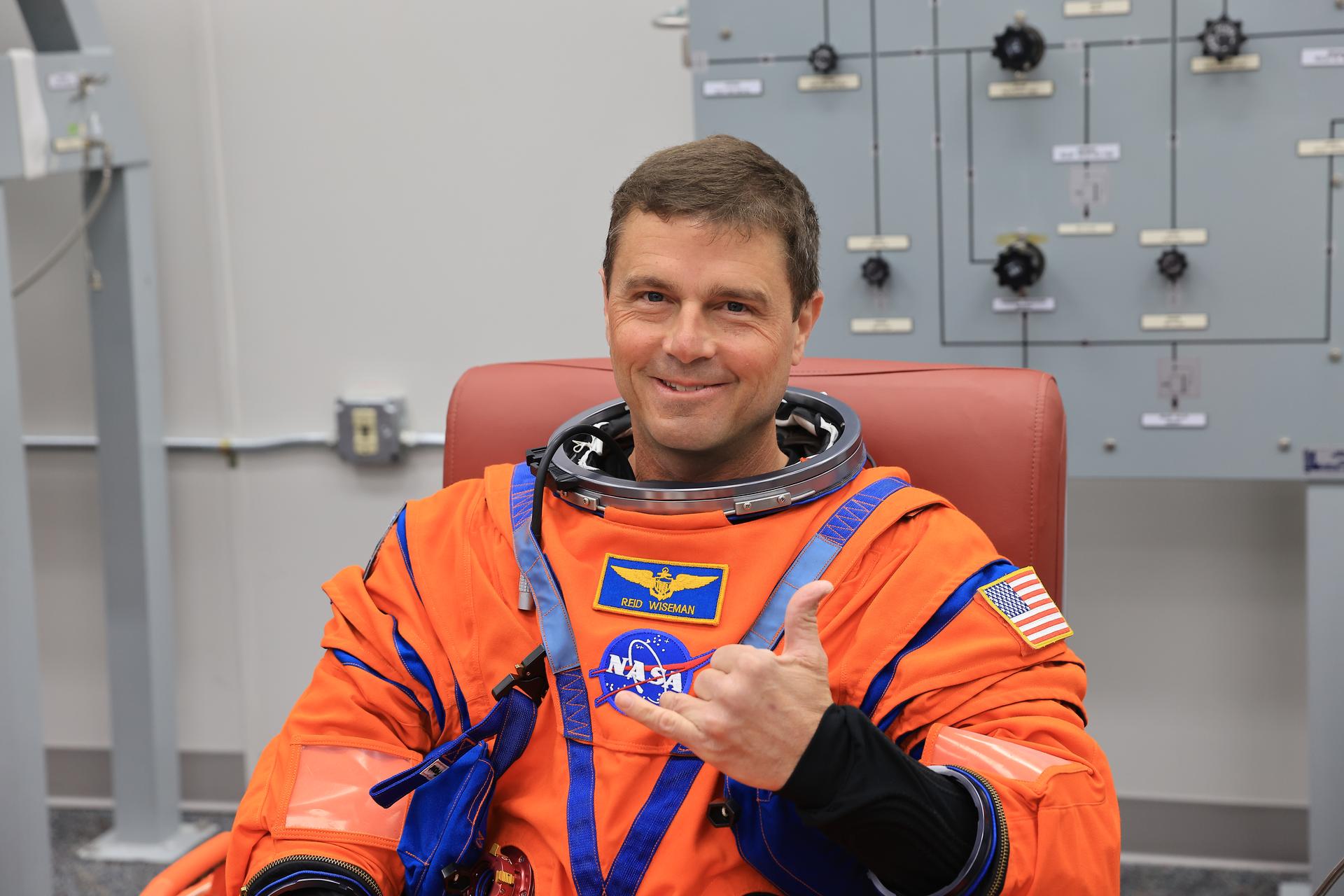 NASA astronaut Reid Wiseman, Artemis II commander, smiles during leak checks on his spacesuit inside the crew suit-up room in the Neil A. Armstrong Operations and Checkout Building at the agency’s Kennedy Space Center in Florida on Wednesday, April 1, 2026, ahead of the Artemis II test flight. The mission will take Wiseman, Pilot Victor Glover, and Mission Specialist Christina Koch from NASA, along with Mission Specialist Jeremy Hansen from the CSA (Canadian Space Agency), on a 10-day journey around the Moon and back aboard NASA’s SLS (Space Launch System) rocket and Orion spacecraft with a two hour launch window opening at 6:24 p.m. EDT from Launch Complex 39B at NASA Kennedy. 