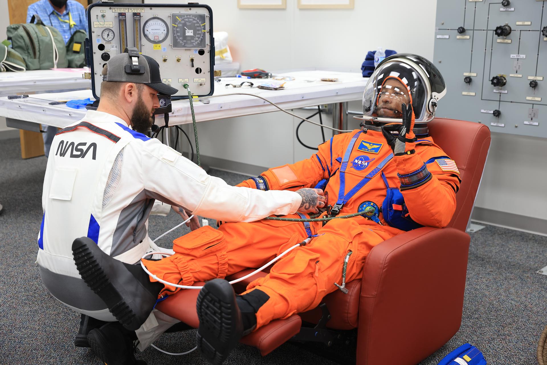 NASA astronaut Victor Glover, Artemis II pilot, conducts leak checks on his spacesuit inside the crew suit-up room in the Neil A. Armstrong Operations and Checkout Building at the agency’s Kennedy Space Center in Florida on Wednesday, April 1, 2026, ahead of the Artemis II test flight. The mission will take Pilot Victor Glover, Commander Reid Wiseman, and Mission Specialist Christina Koch from NASA, along with Mission Specialist Jeremy Hansen from the CSA (Canadian Space Agency) on a 10-day journey around the Moon and back aboard NASA’s SLS (Space Launch System) rocket and Orion spacecraft with a two hour launch window opening at 6:24 p.m. EDT from Launch Complex 39B at NASA Kennedy. 