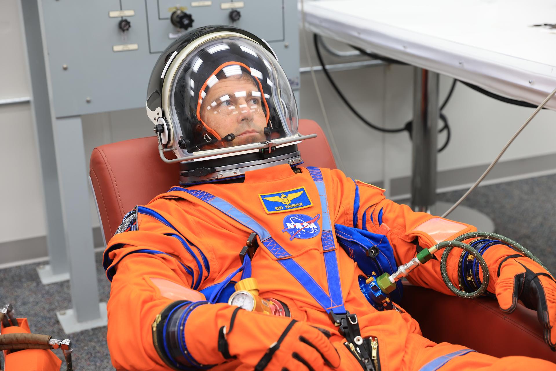 NASA astronaut Reid Wiseman, Artemis II commander, conducts leak checks on his spacesuit inside the crew suit-up room in the Neil A. Armstrong Operations and Checkout Building at the agency’s Kennedy Space Center in Florida on Wednesday, April 1, 2026, ahead of the Artemis II test flight. The mission will take Wiseman, Pilot Victor Glover, and Mission Specialist Christina Koch from NASA, along with Mission Specialist Jeremy Hansen from the CSA (Canadian Space Agency), on a 10-day journey around the Moon and back aboard NASA’s SLS (Space Launch System) rocket and Orion spacecraft with a two hour launch window opening at 6:24 p.m. EDT from Launch Complex 39B at NASA Kennedy. 