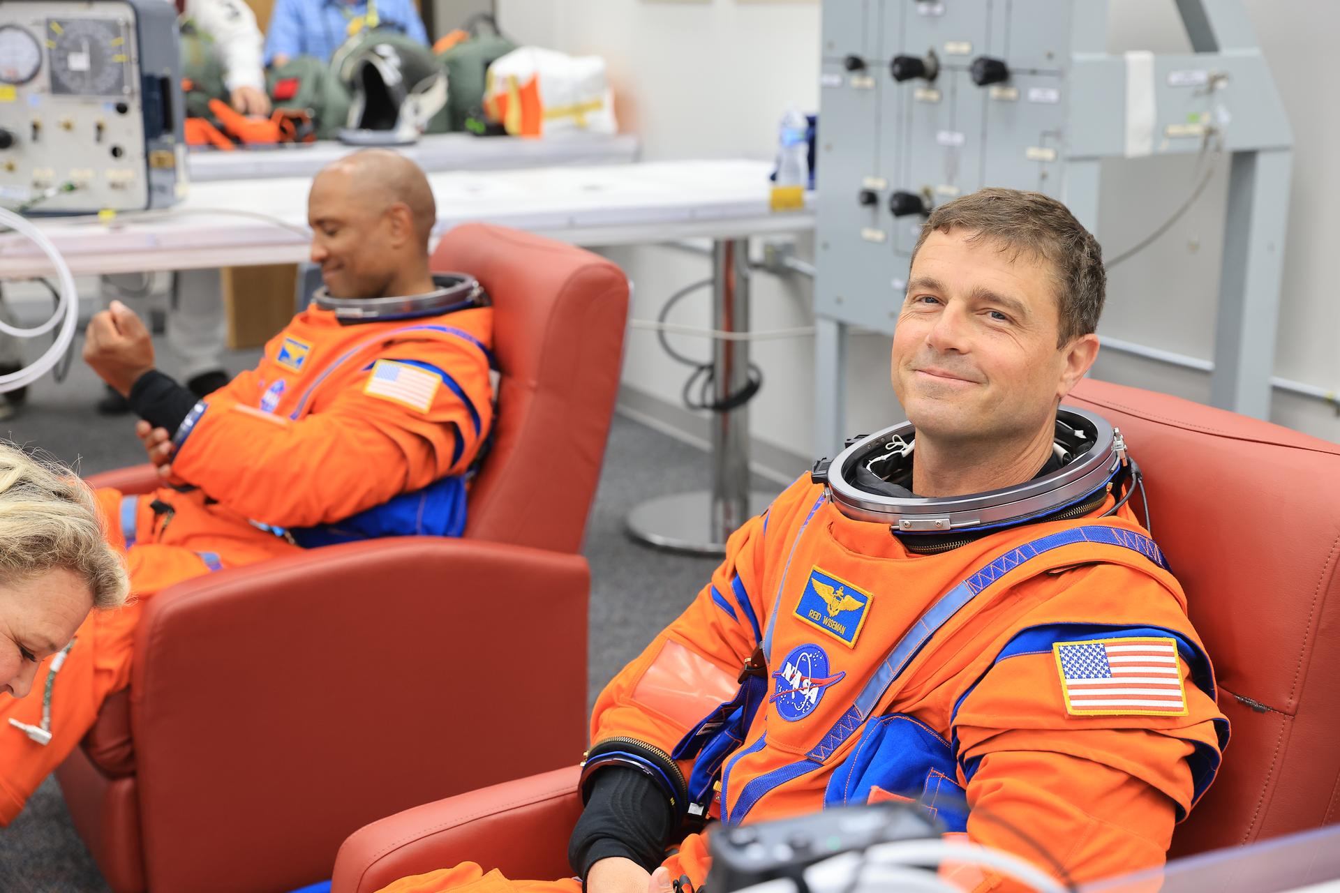 From left, NASA astronauts Victor Glover, Artemis II pilot and Reid Wiseman, Artemis II commander, conduct leak checks on his spacesuit inside the crew suit-up room in the Neil A. Armstrong Operations and Checkout Building at the agency’s Kennedy Space Center in Florida on Wednesday, April 1, 2026, ahead of the Artemis II test flight. The mission will take Wiseman, Pilot Victor Glover, and Mission Specialist Christina Koch from NASA, along with Mission Specialist Jeremy Hansen from the CSA (Canadian Space Agency), on a 10-day journey around the Moon and back aboard NASA’s SLS (Space Launch System) rocket and Orion spacecraft with a two hour launch window opening at 6:24 p.m. EDT from Launch Complex 39B at NASA Kennedy. 