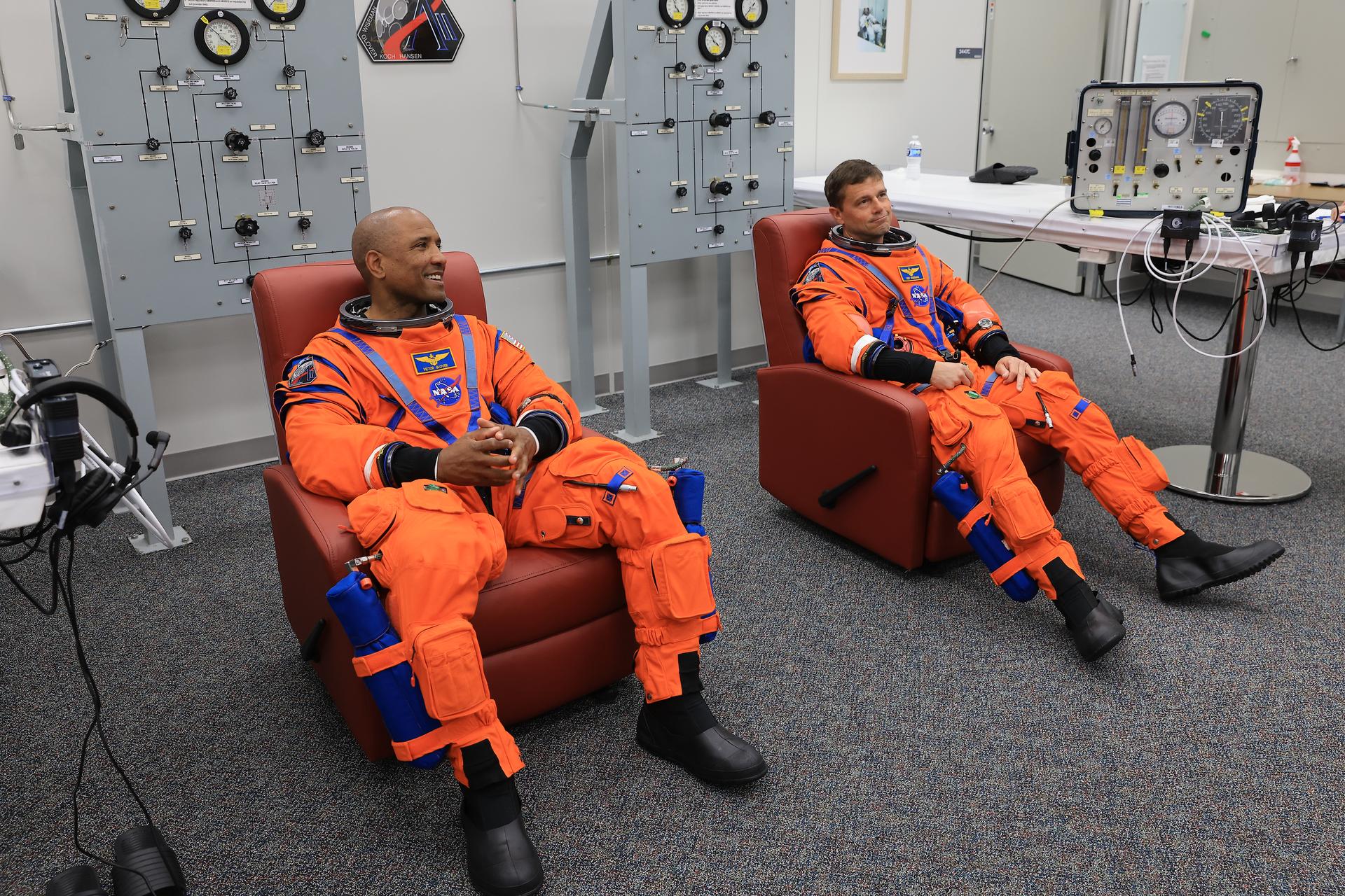 From left, NASA astronauts Victor Glover, Artemis II pilot and Reid Wiseman, Artemis II commander, conduct leak checks on his spacesuit inside the crew suit-up room in the Neil A. Armstrong Operations and Checkout Building at the agency’s Kennedy Space Center in Florida on Wednesday, April 1, 2026, ahead of the Artemis II test flight. The mission will take Wiseman, Pilot Victor Glover, and Mission Specialist Christina Koch from NASA, along with Mission Specialist Jeremy Hansen from the CSA (Canadian Space Agency), on a 10-day journey around the Moon and back aboard NASA’s SLS (Space Launch System) rocket and Orion spacecraft with a two hour launch window opening at 6:24 p.m. EDT from Launch Complex 39B at NASA Kennedy. 