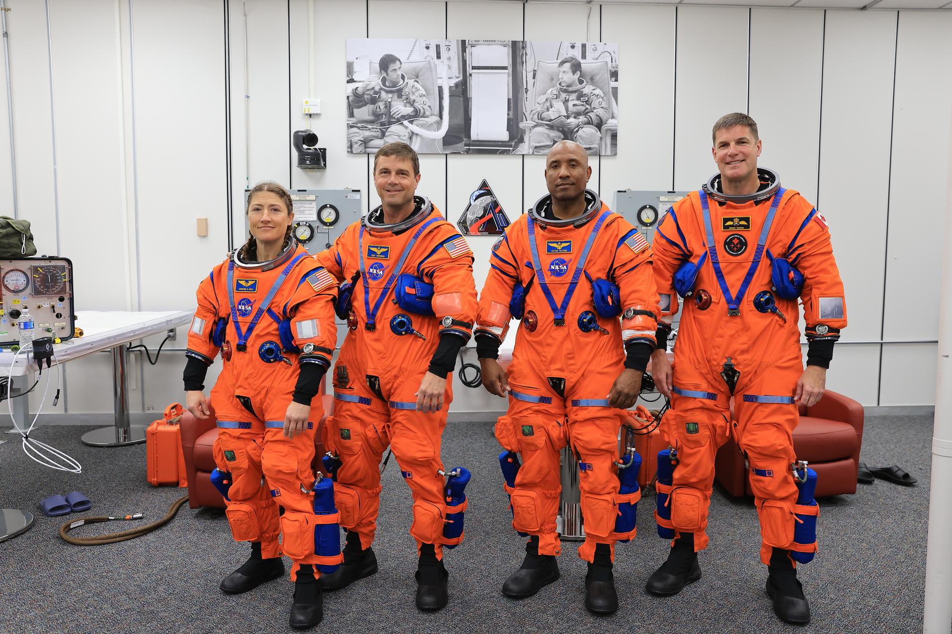 From left, Artemis II Mission Specialist Christina Koch, Commander Reid Wiseman, and Pilot Victor Glover, from NASA, along with Mission Specialist Jeremy Hansen from the CSA (Canadian Space Agency) complete leak checks on their spacesuits inside the crew suit-up room in the Neil A. Armstrong Operations and Checkout Building at the agency’s Kennedy Space Center in Florida on Wednesday, April 1, 2026, ahead of the Artemis II test flight. The mission will take the crew on a 10-day journey around the Moon and back aboard NASA’s SLS (Space Launch System) rocket and Orion spacecraft with a two hour launch window opening at 6:24 p.m. EDT from Launch Complex 39B at NASA Kennedy. 