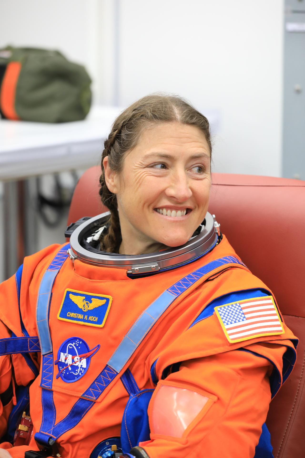 NASA astronaut Christina Koch, Artemis II mission specialist, smiles during leak checks on her spacesuit inside the crew suit-up room in the Neil A. Armstrong Operations and Checkout Building at the agency’s Kennedy Space Center in Florida on Wednesday, April 1, 2026, ahead of the Artemis II test flight. The mission will take Koch, Commander Reid Wiseman, and Pilot Victor Glover, from NASA, along with Mission Specialist Jeremy Hansen from the CSA (Canadian Space Agency) on a 10-day journey around the Moon and back aboard NASA’s SLS (Space Launch System) rocket and Orion spacecraft with a two-hour launch window opening at 6:24 p.m. EDT from Launch Complex 39B at NASA Kennedy. 