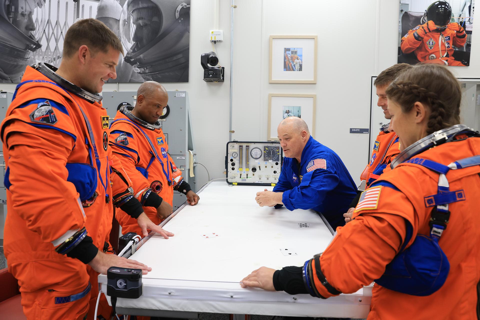 Artemis II crew members play the traditional card game with NASA astronaut chief Scott Tingle, inside the Neil A. Armstrong Operations and Checkout Building at the agency’s Kennedy Space Center in Florida on Wednesday, April 1, 2026, ahead of the Artemis II test flight. The mission will take Artemis II Commander Reid Wiseman, Pilot Victor Glover, and Mission Specialist Christina Koch from NASA, along with Mission Specialist Jeremy Hansen from the CSA (Canadian Space Agency), on a 10-day journey around the Moon and back aboard NASA’s SLS (Space Launch System) rocket and Orion spacecraft with a two hour launch window opening at 6:24 p.m. EDT from Launch Complex 39B at NASA Kennedy. 