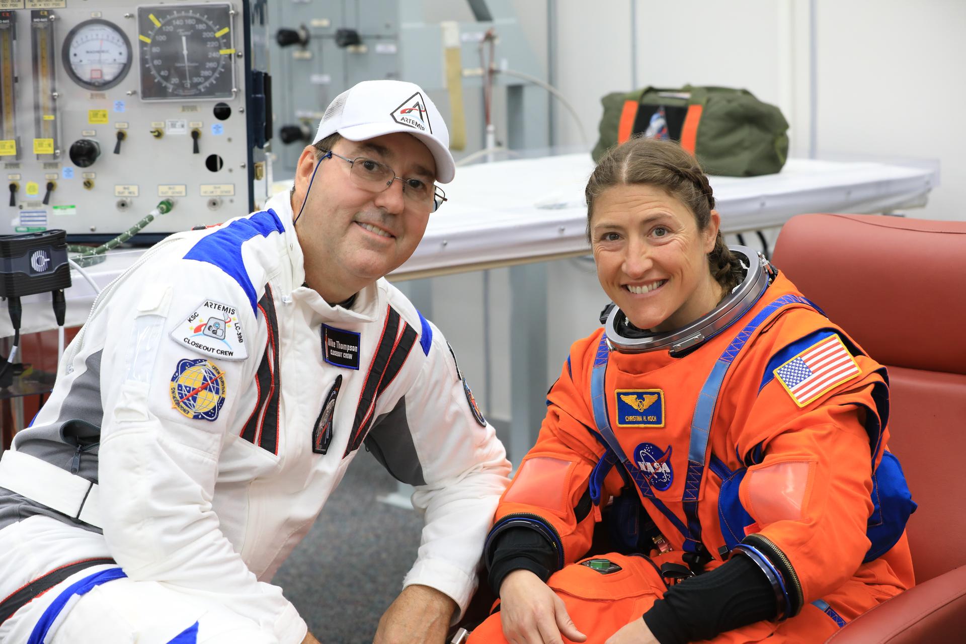 From left, a member of the Artemis closeout crew and NASA astronaut Christina Koch, Artemis II mission specialist, conducts leak checks on her spacesuit inside the crew suit-up room in the Neil A. Armstrong Operations and Checkout Building at the agency’s Kennedy Space Center in Florida on Wednesday, April 1, 2026, ahead of the Artemis II test flight. The mission will take Koch, Commander Reid Wiseman, and Pilot Victor Glover, from NASA, along with Mission Specialist Jeremy Hansen from the CSA (Canadian Space Agency) on a 10-day journey around the Moon and back aboard NASA’s SLS (Space Launch System) rocket and Orion spacecraft with a two-hour launch window opening at 6:24 p.m. EDT from Launch Complex 39B at NASA Kennedy. 