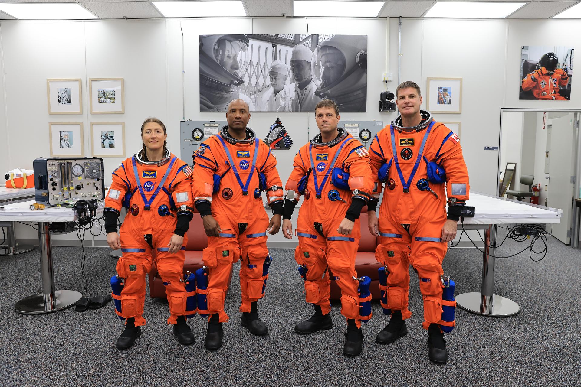 From left, Artemis II Mission Specialist Christina Koch, Pilot Victor Glover, and Commander Reid Wiseman, from NASA, along with Mission Specialist Jeremy Hansen from the CSA (Canadian Space Agency) complete leak checks on their spacesuits inside the crew suit-up room in the Neil A. Armstrong Operations and Checkout Building at the agency’s Kennedy Space Center in Florida on Wednesday, April 1, 2026, ahead of the Artemis II test flight. The mission will take the crew on a 10-day journey around the Moon and back aboard NASA’s SLS (Space Launch System) rocket and Orion spacecraft with a two hour launch window opening at 6:24 p.m. EDT from Launch Complex 39B at NASA Kennedy. 