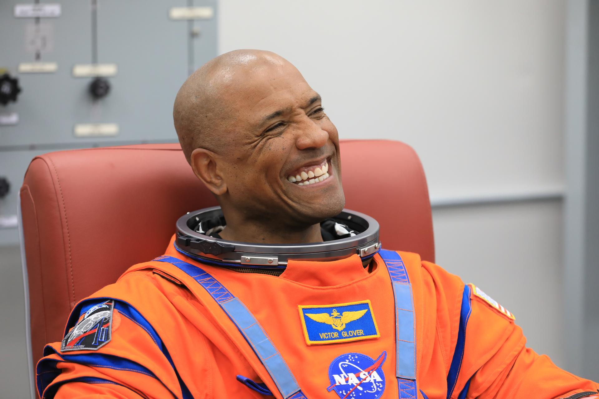 NASA astronaut Victor Glover, Artemis II pilot, smiles during leak checks on his spacesuit inside the crew suit-up room in the Neil A. Armstrong Operations and Checkout Building at the agency’s Kennedy Space Center in Florida on Wednesday, April 1, 2026, ahead of the Artemis II test flight. The mission will take Pilot Victor Glover, Commander Reid Wiseman, and Mission Specialist Christina Koch from NASA, along with Mission Specialist Jeremy Hansen from the CSA (Canadian Space Agency) on a 10-day journey around the Moon and back aboard NASA’s SLS (Space Launch System) rocket and Orion spacecraft with a two hour launch window opening at 6:24 p.m. EDT from Launch Complex 39B at NASA Kennedy.